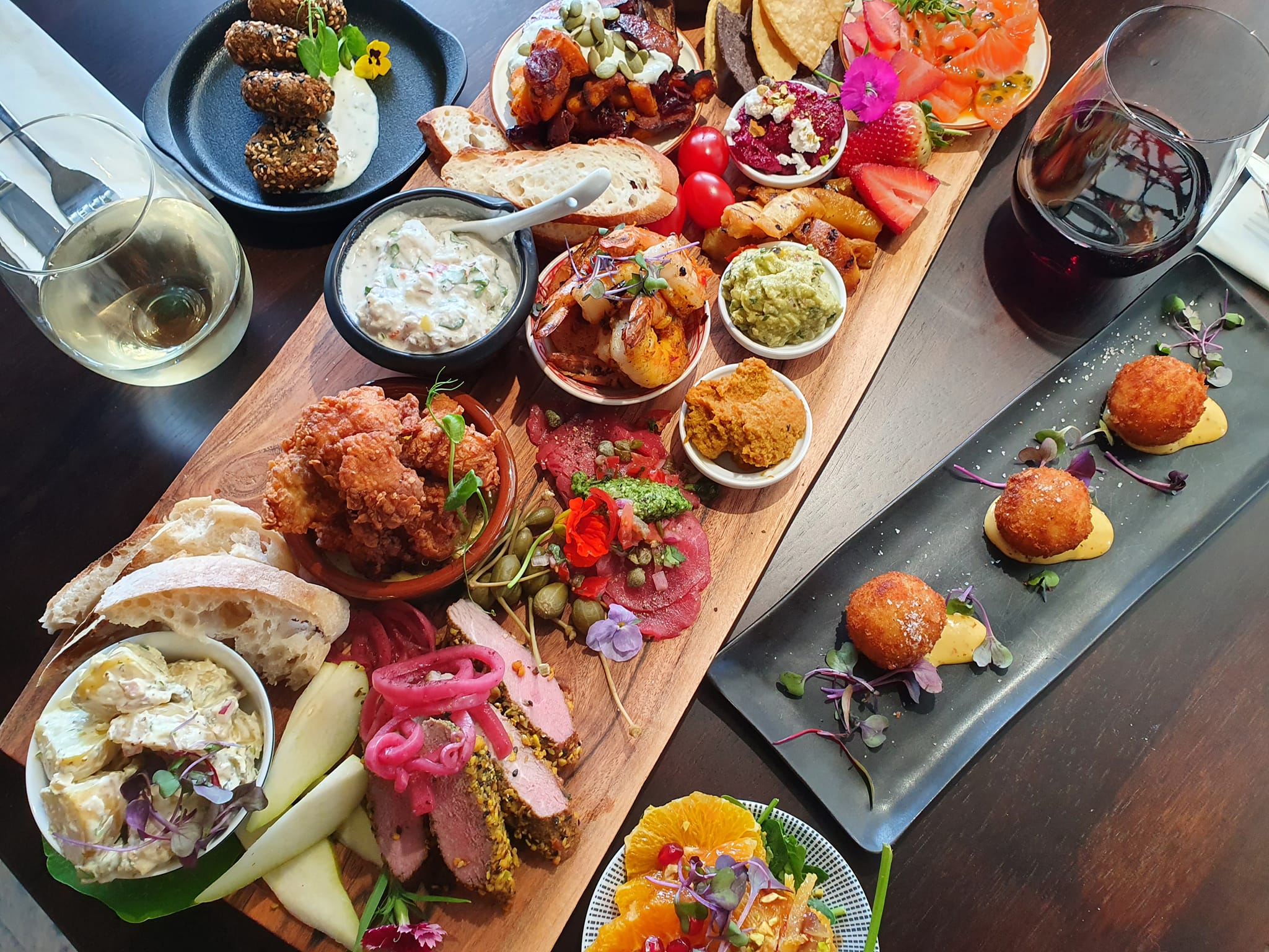 Large platter of delicious food and wine