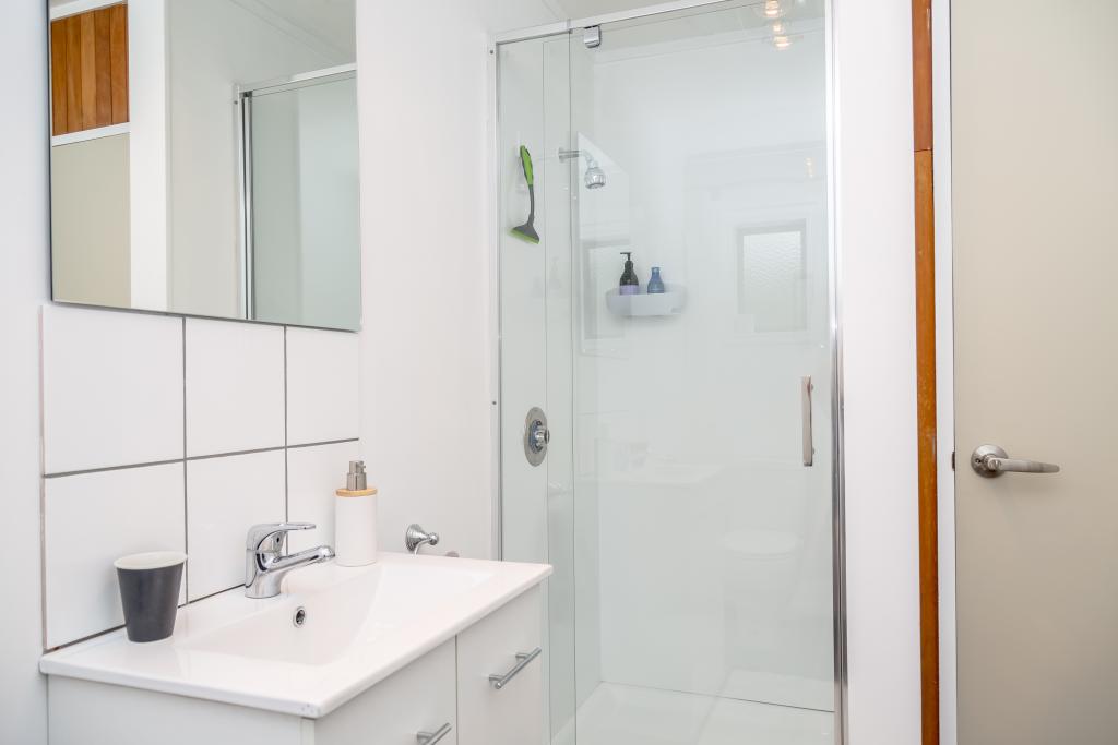 Bathroom with shower and washing machine