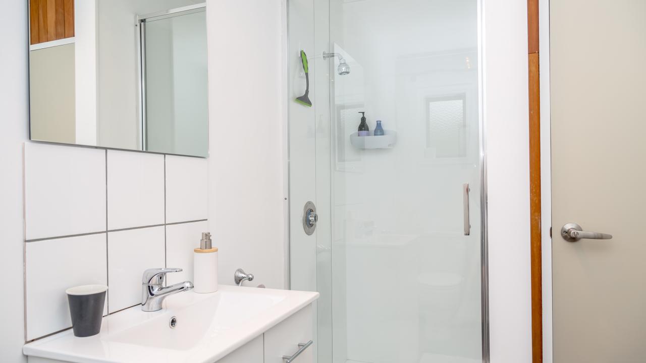 Bathroom with shower and washing machine