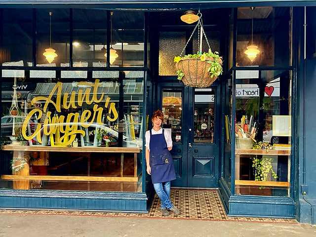 Lady standing outside shop 