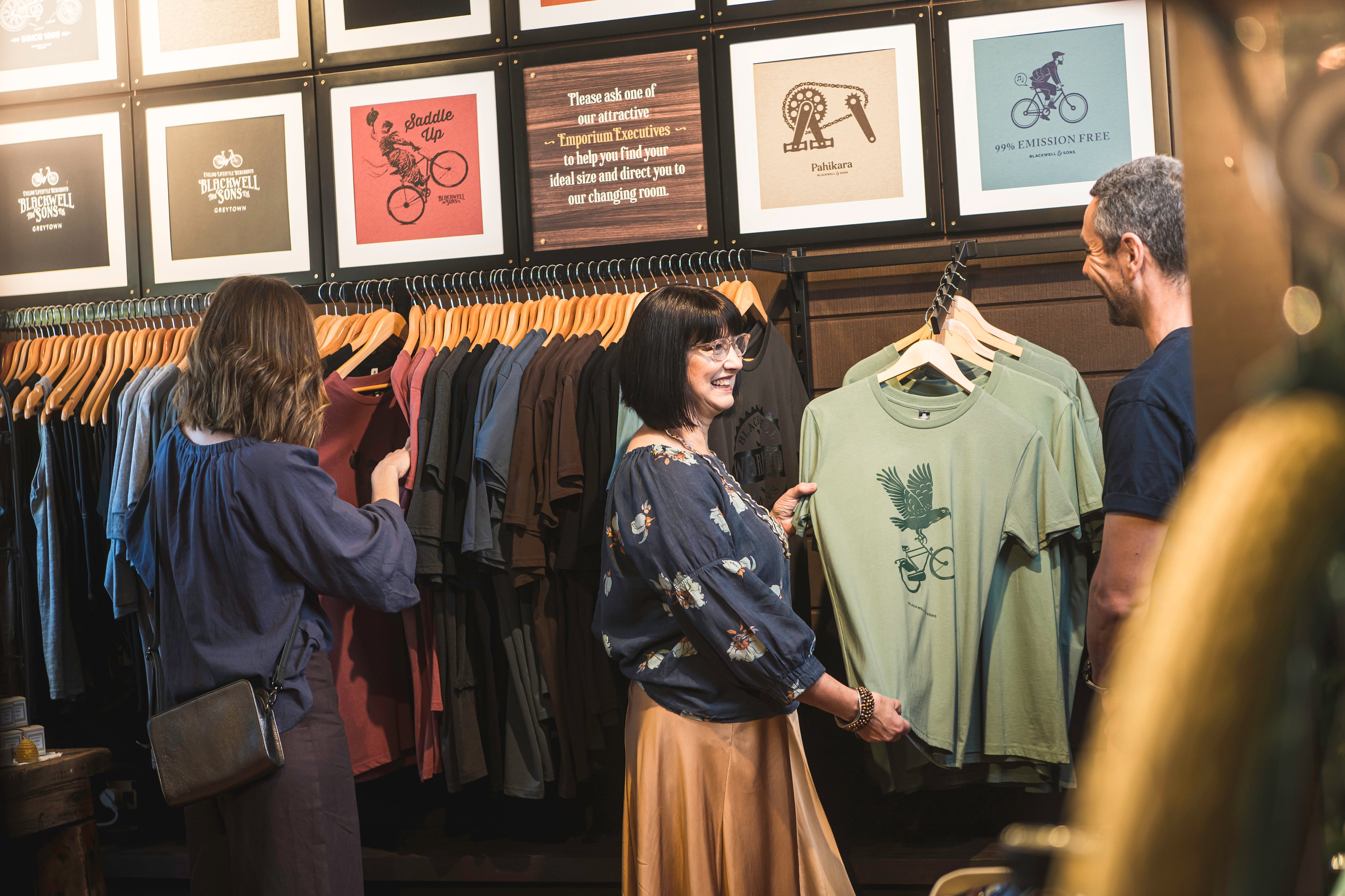 People looking at t-shirts in shop 