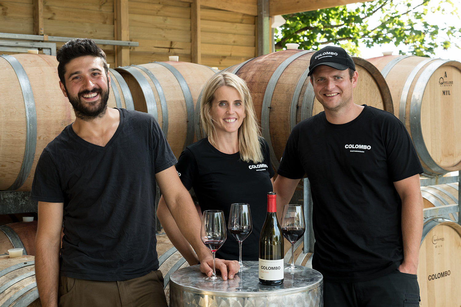 People in front of wine barrels 