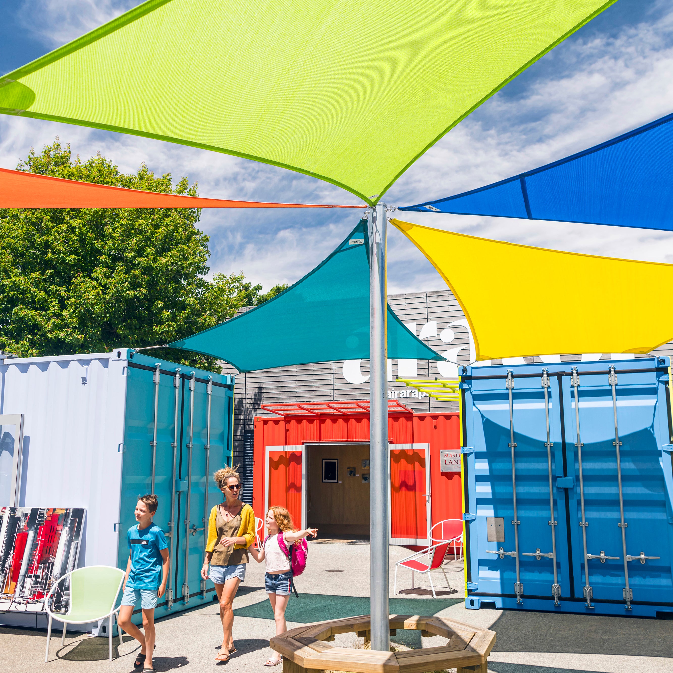 Family walking through colourful containers 