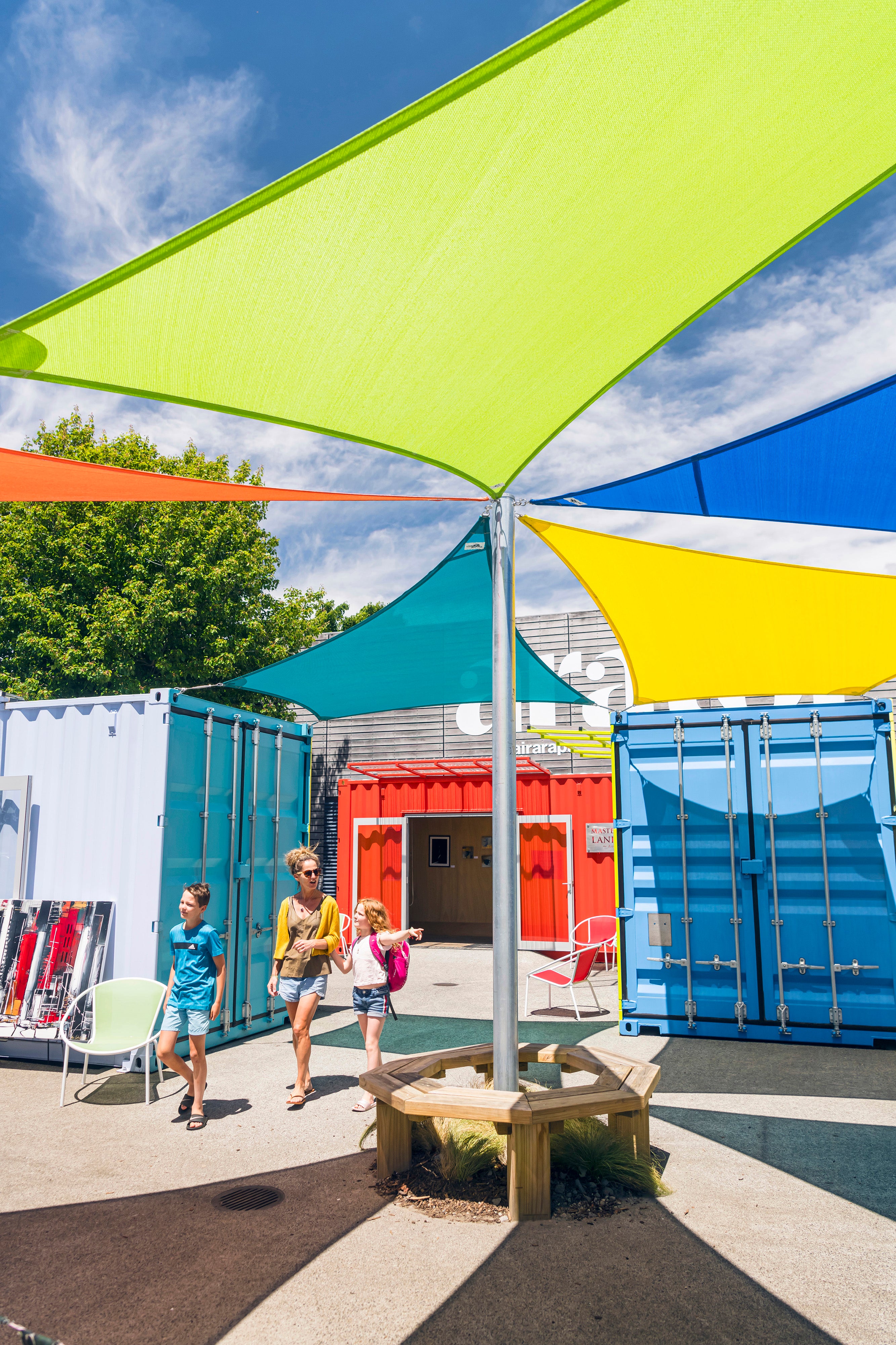 Family walking through colourful containers 