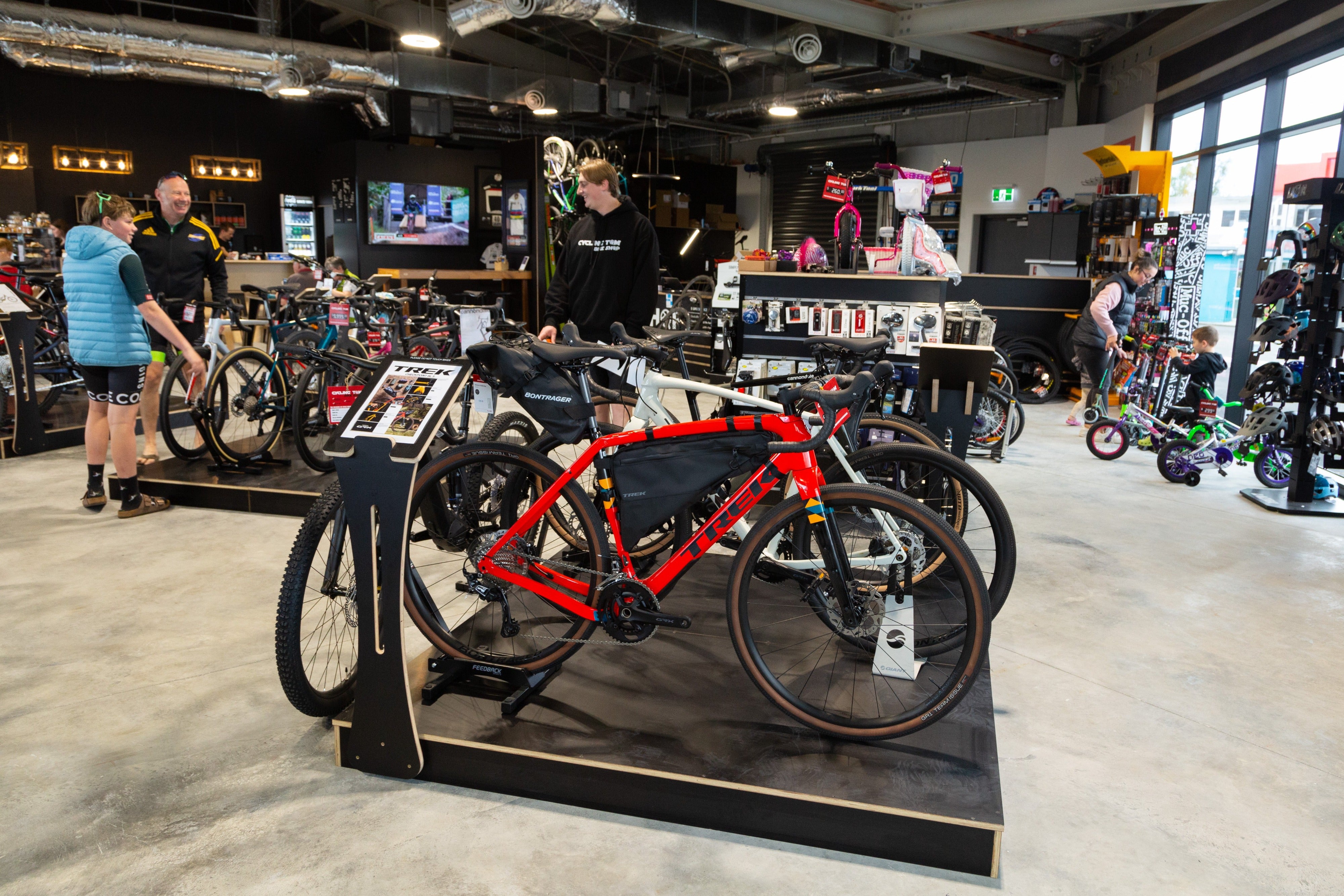 People browsing bikes in bike shop