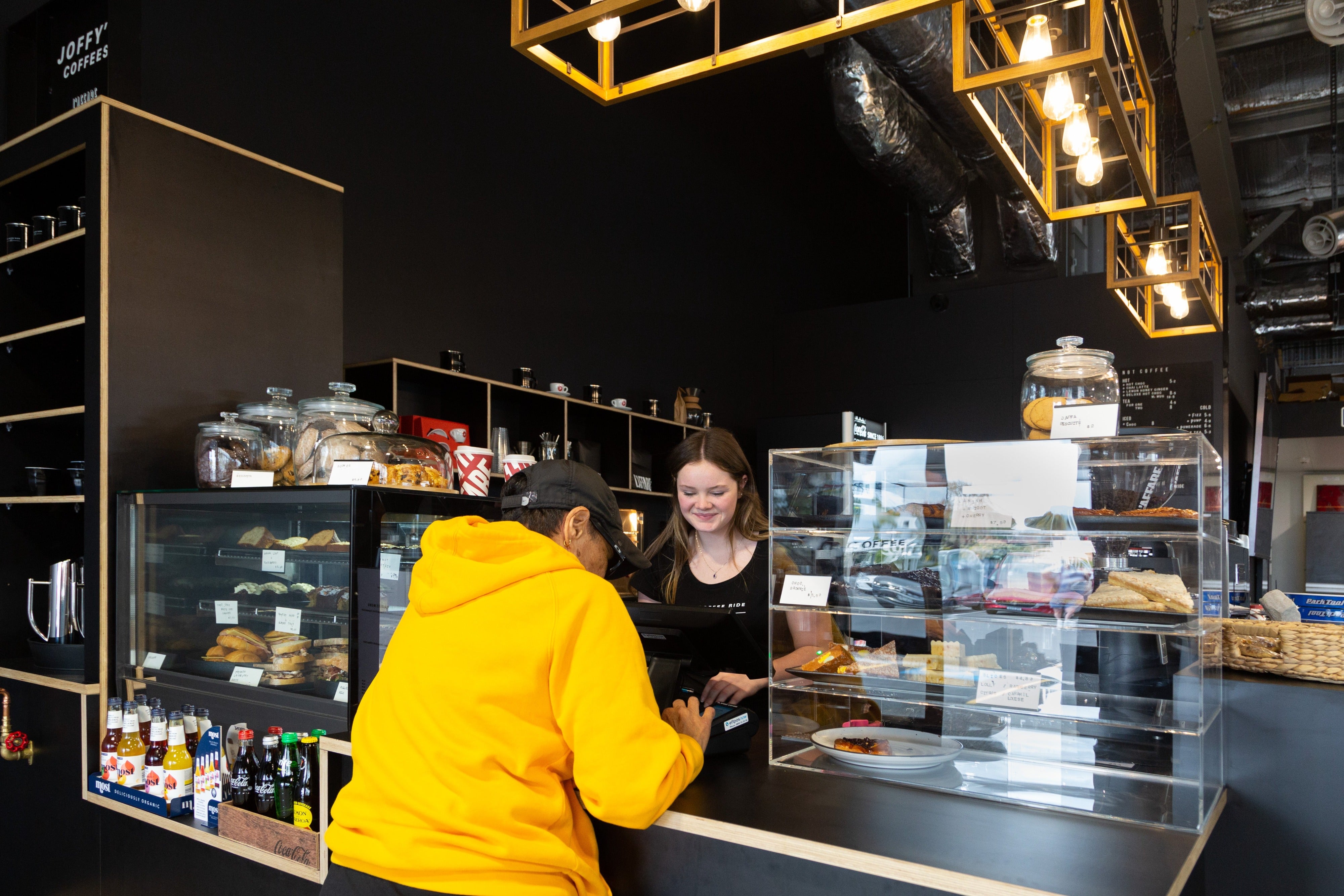 Girl serving at café in bike store