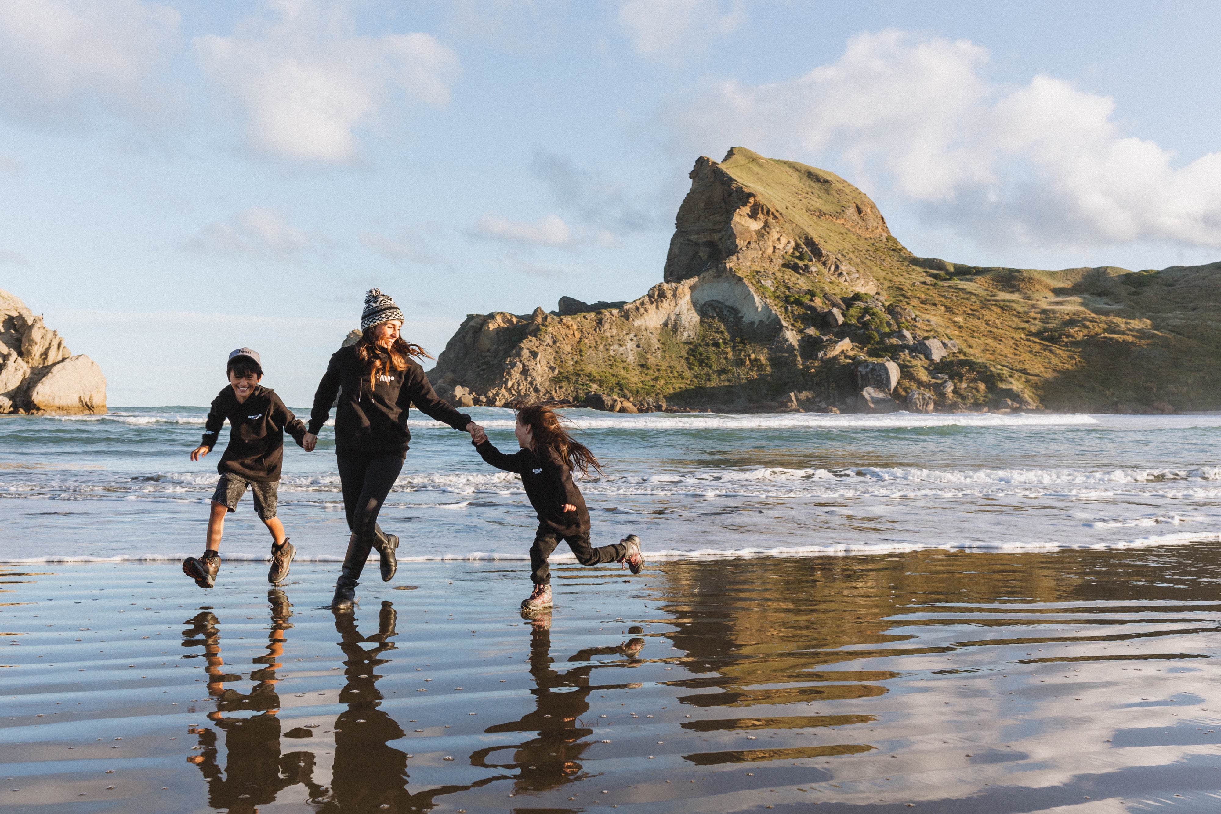 Family running along the beach 