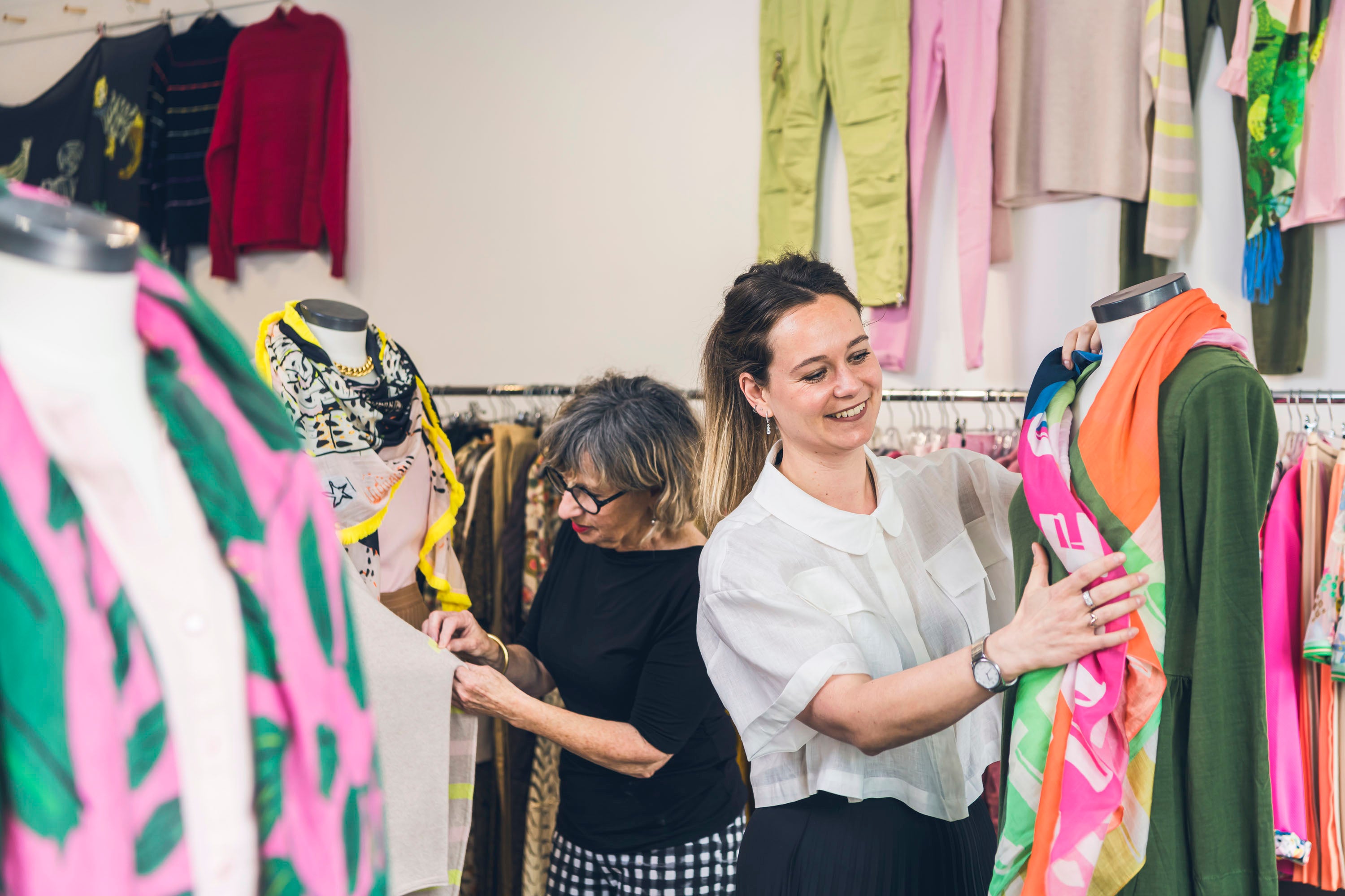 Ladies looking through racks of clothes 