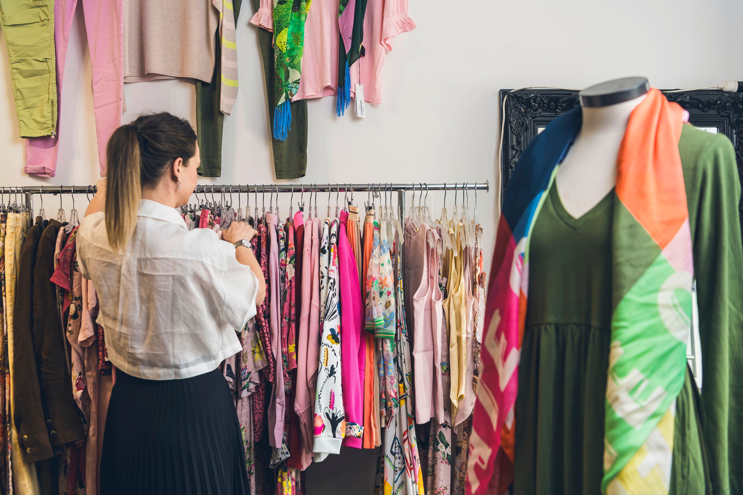 Lady looking at rack of clothes 