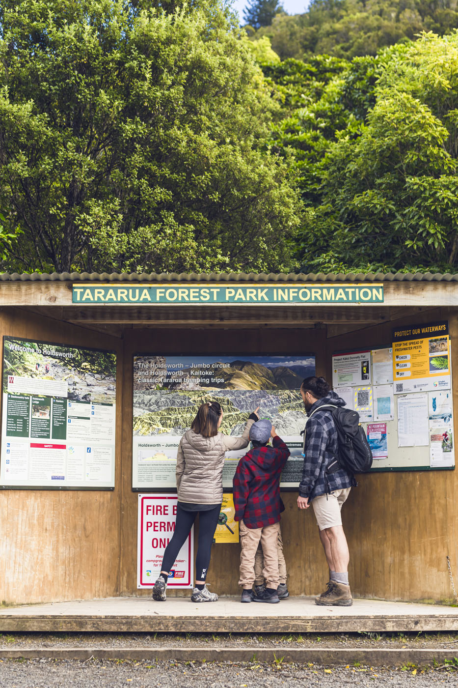 Family checking out map at entrance to walk 