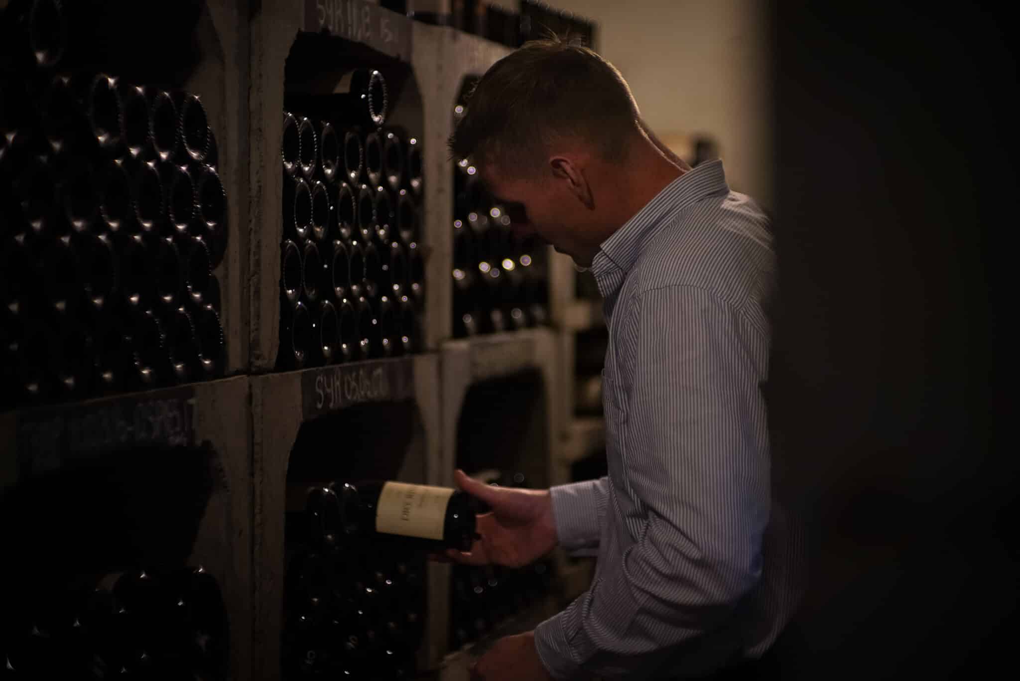 Man putting wine in cellar 