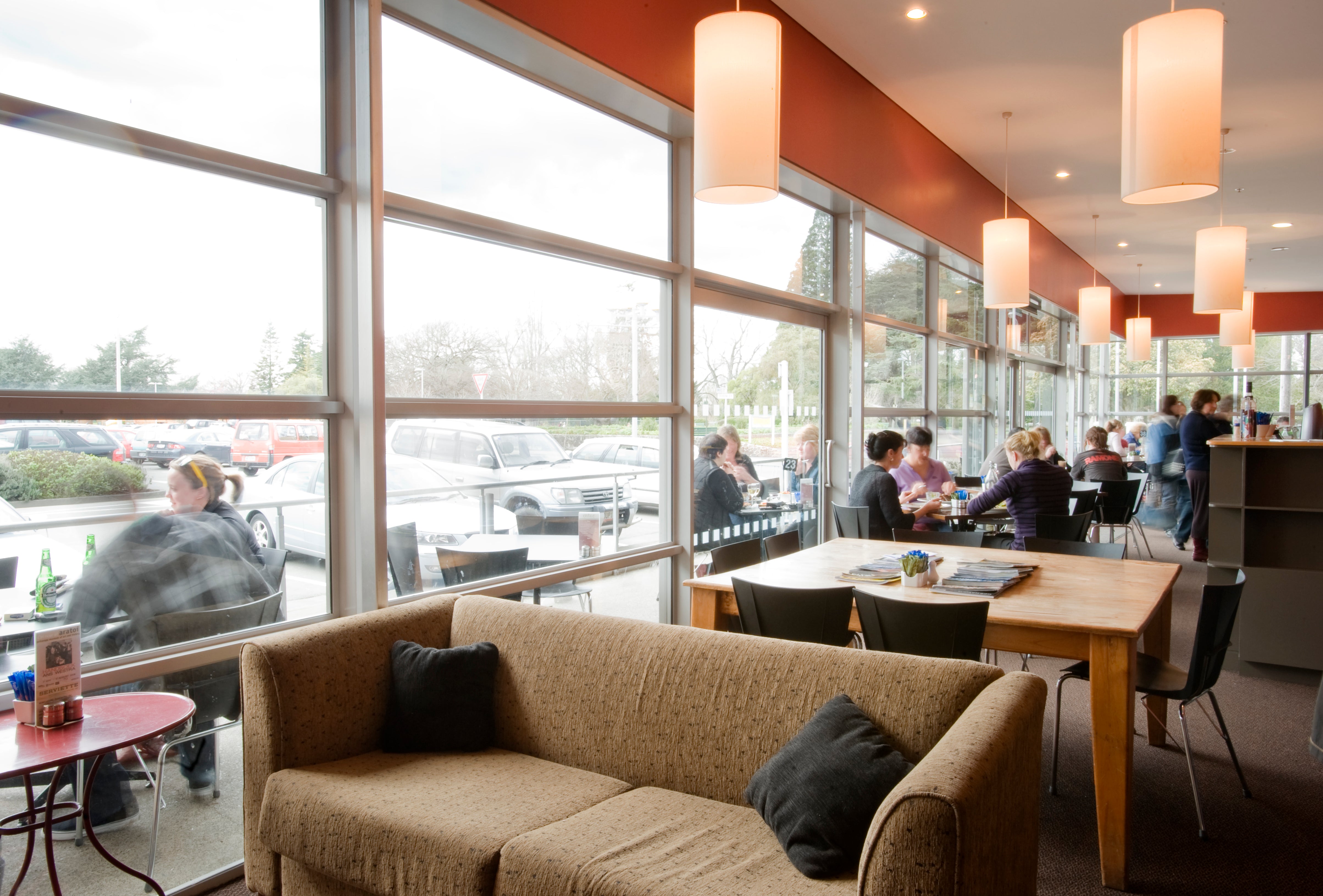 Customers sitting at tables in cafe 