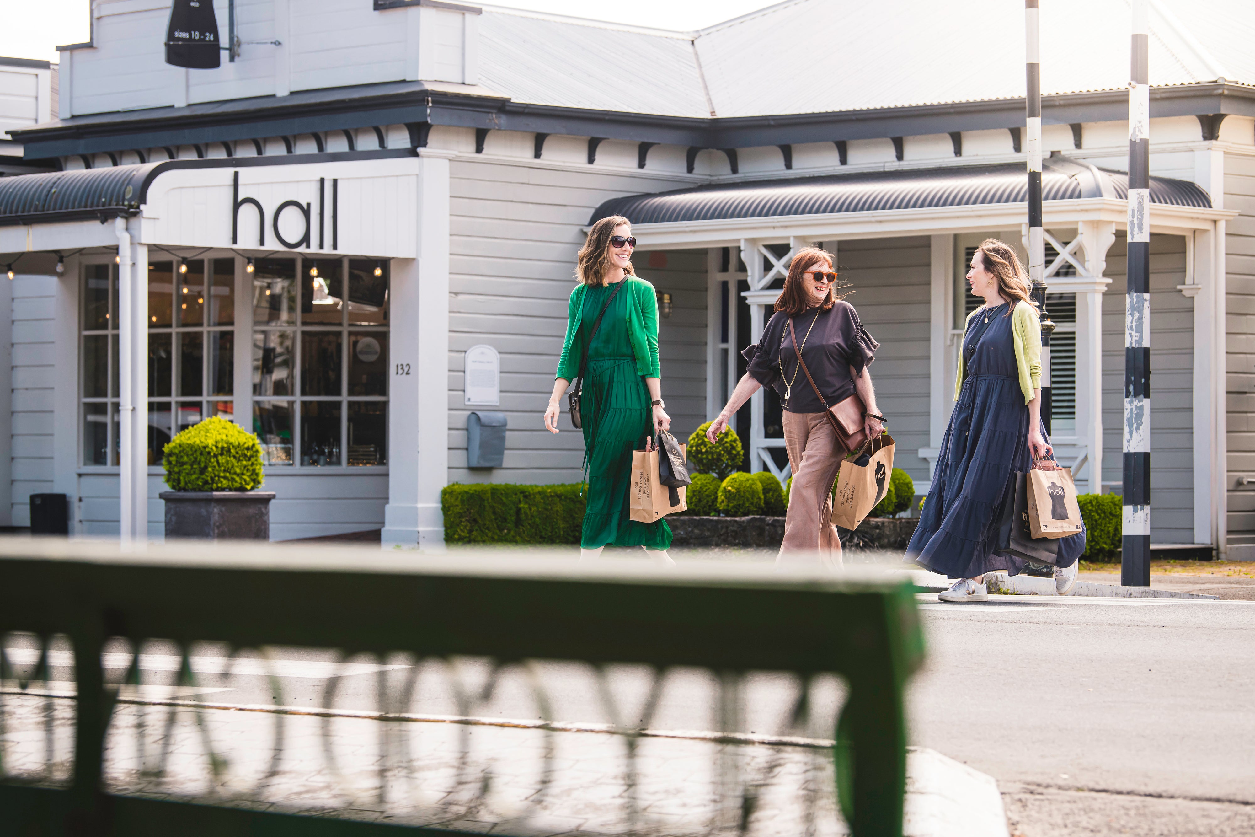 Ladies walking in front of store with shopping bags 