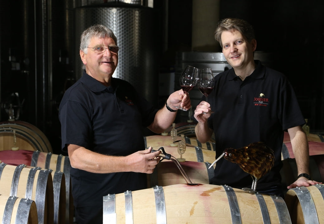 The owners in the cellar toasting wine 