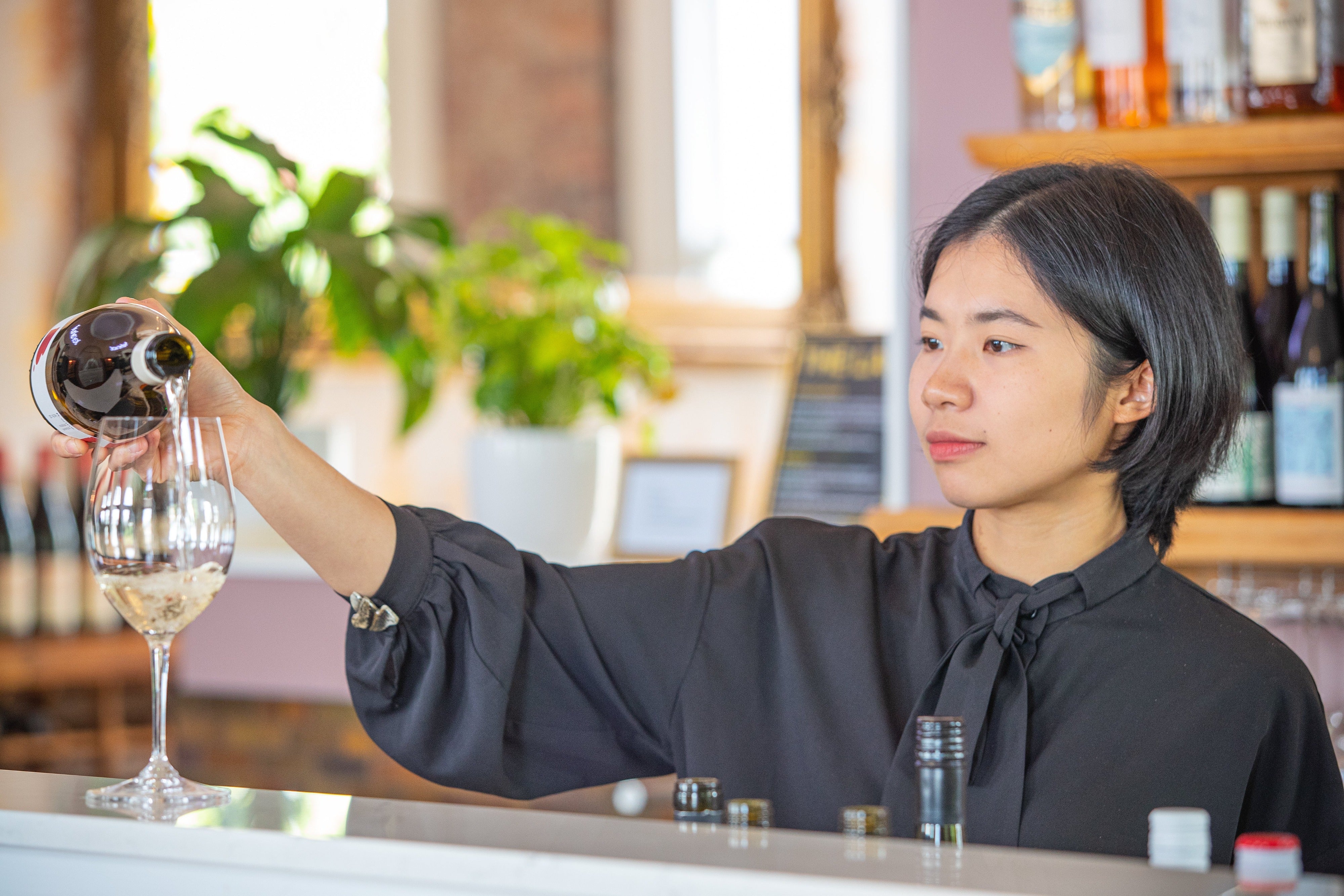 Lady pouring glass of wine