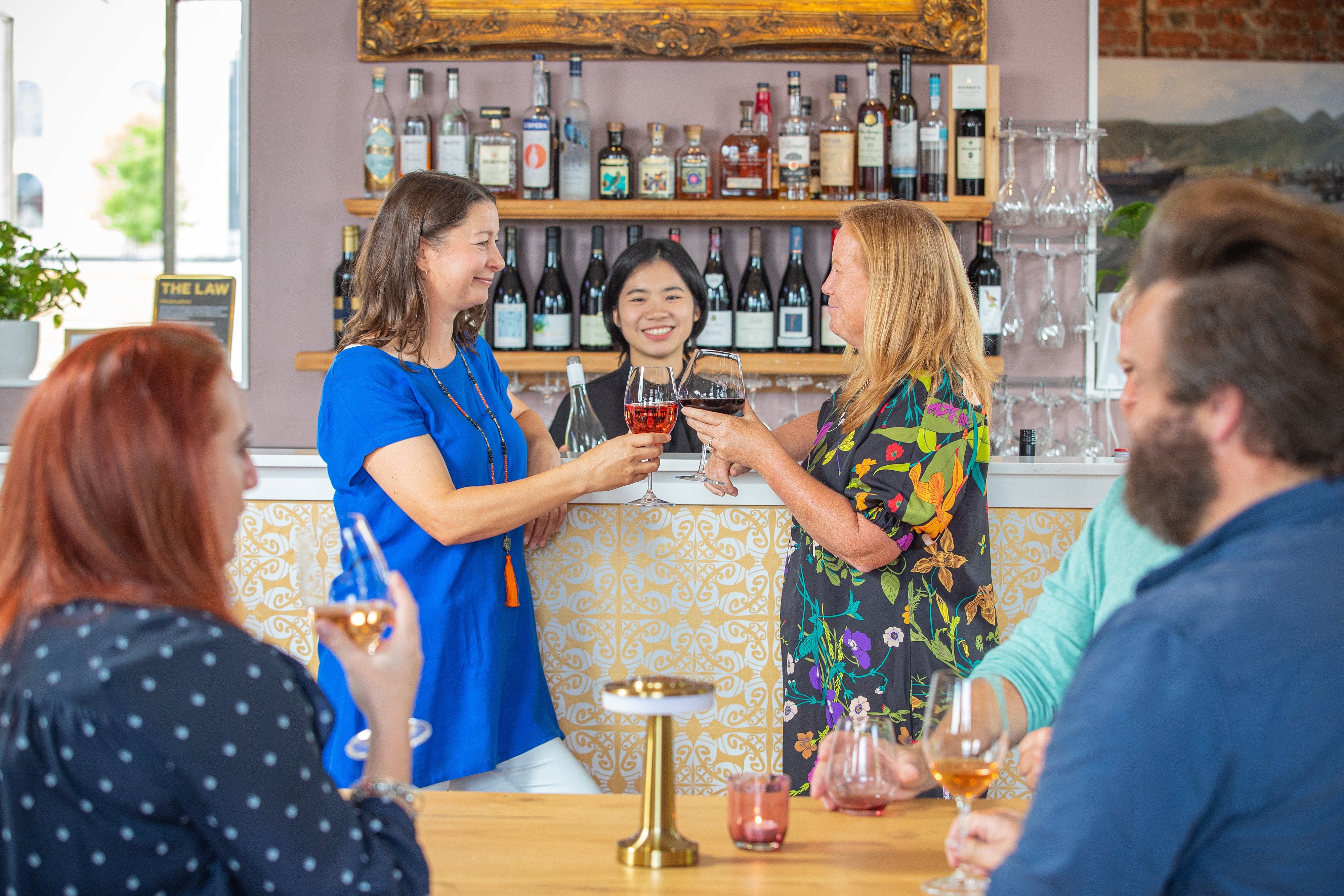 Customers toasting glasses of wine