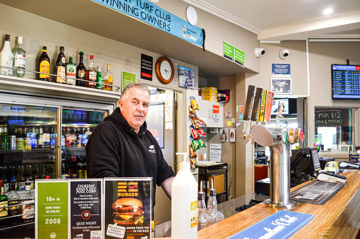 Man waiting at bar ready to serve customers