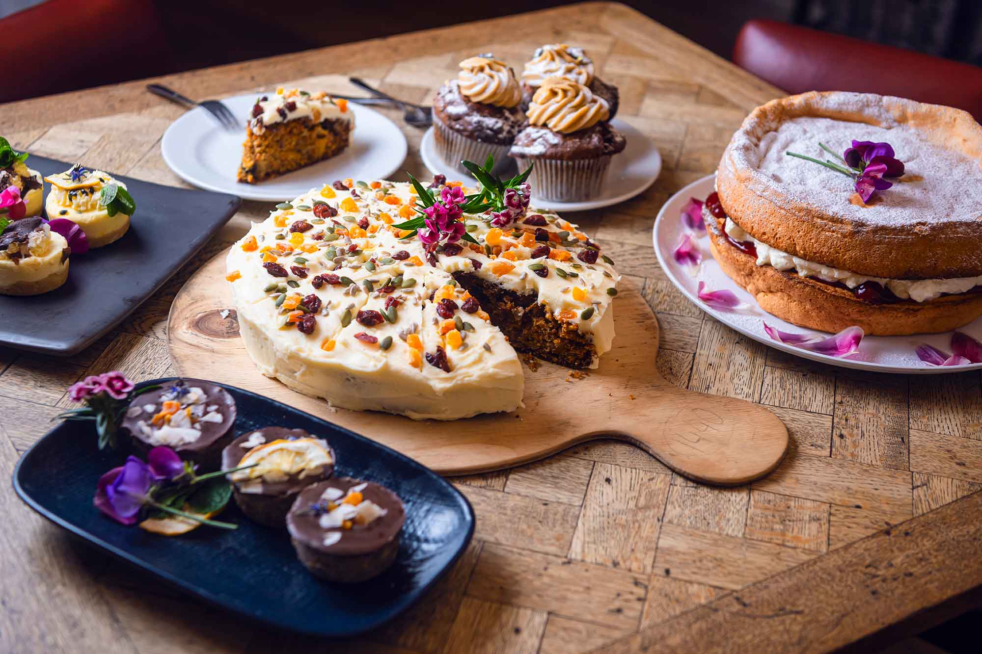 Assorted cakes and pastries on a wooden table