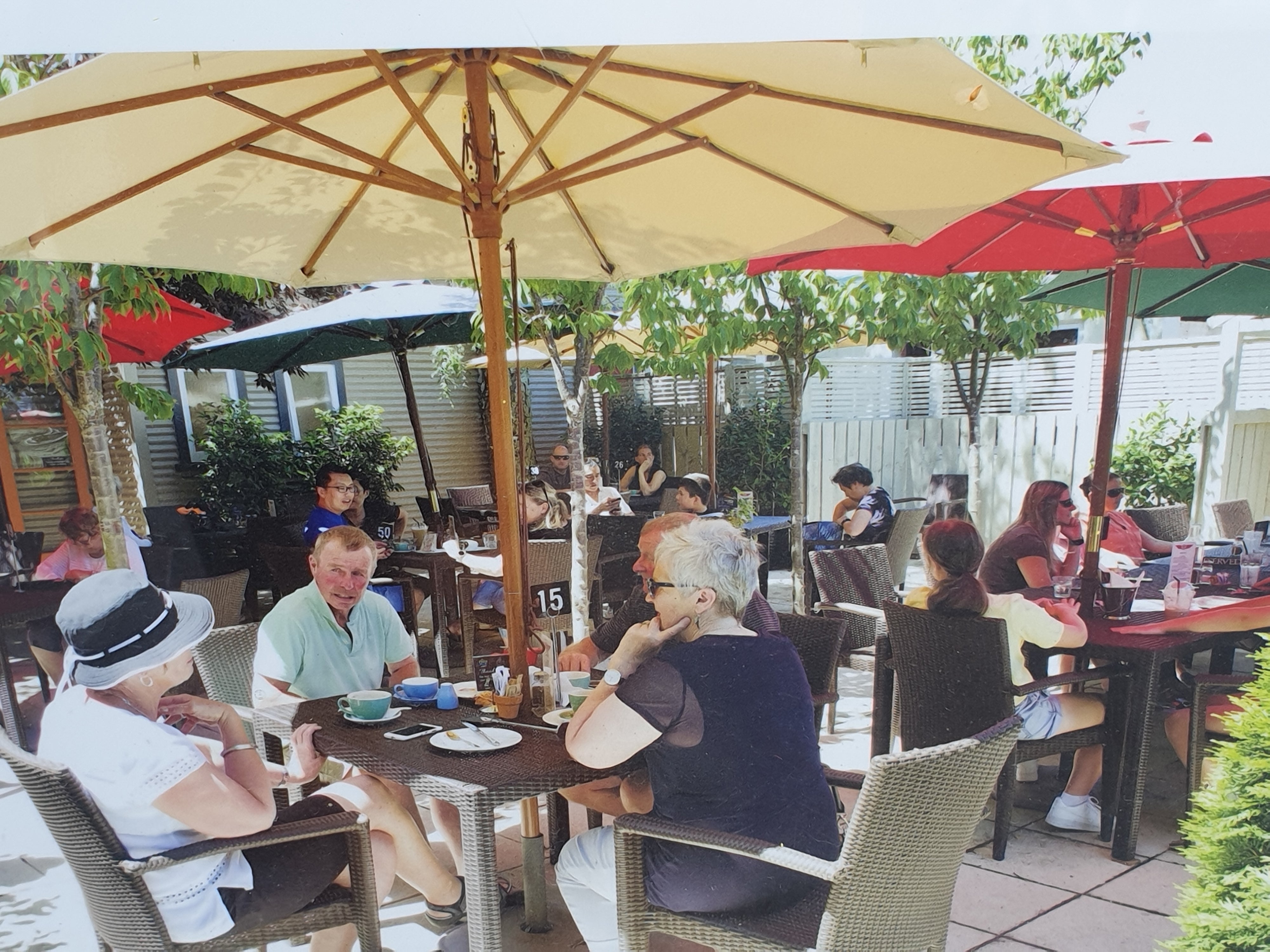 People at tables in courtyard 