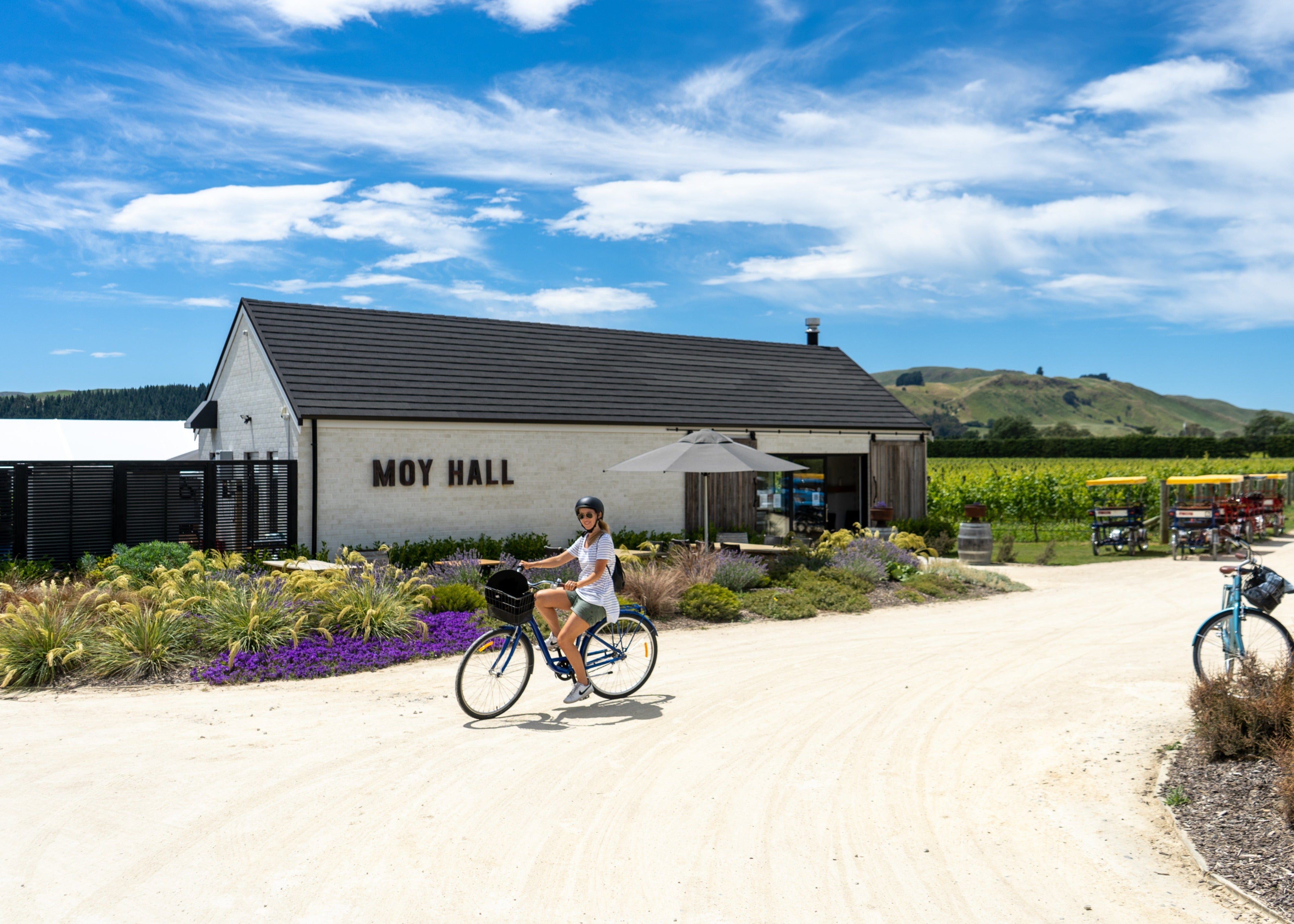 Girl cycling outside winery