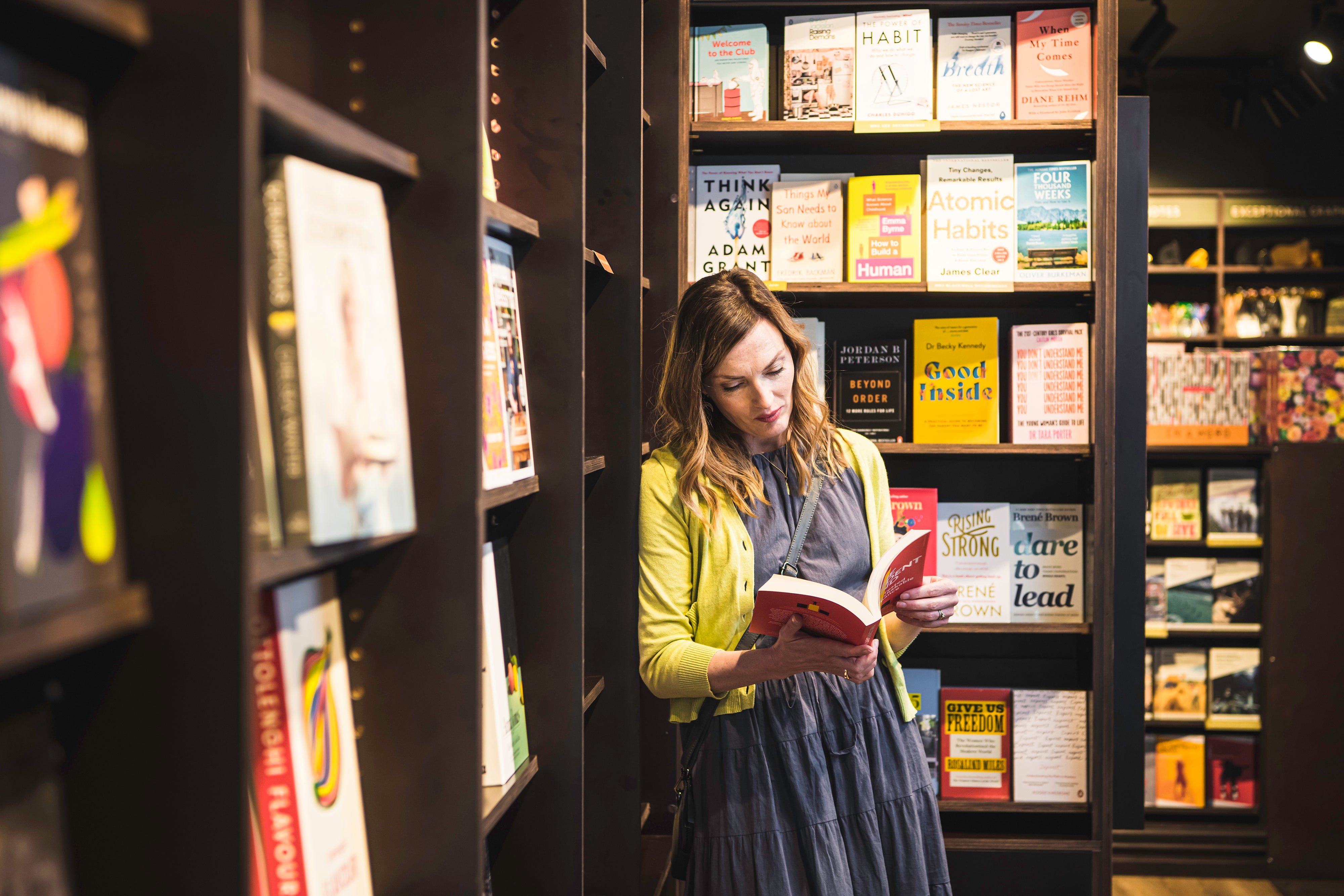 Lady browsing book in shop 