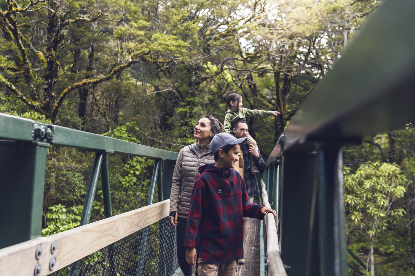 Family walking through native trees