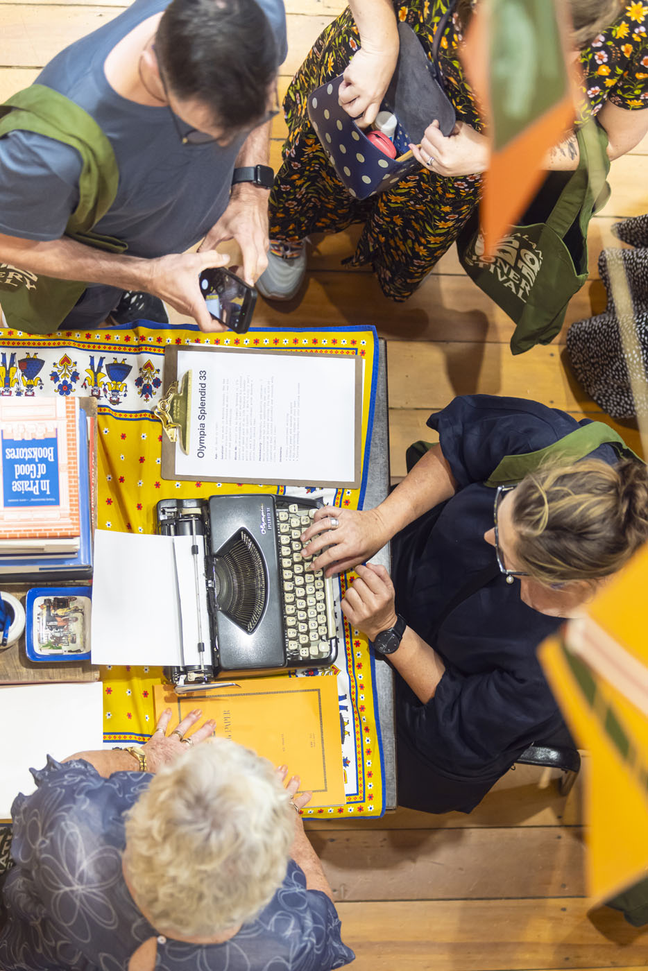 Looking down at a lady using an old-fashioned typewriter