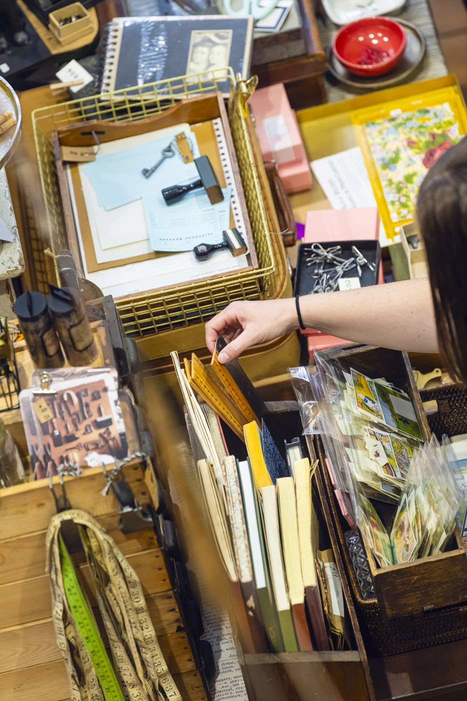 Lady looking through stationary items like rulers and notebooks