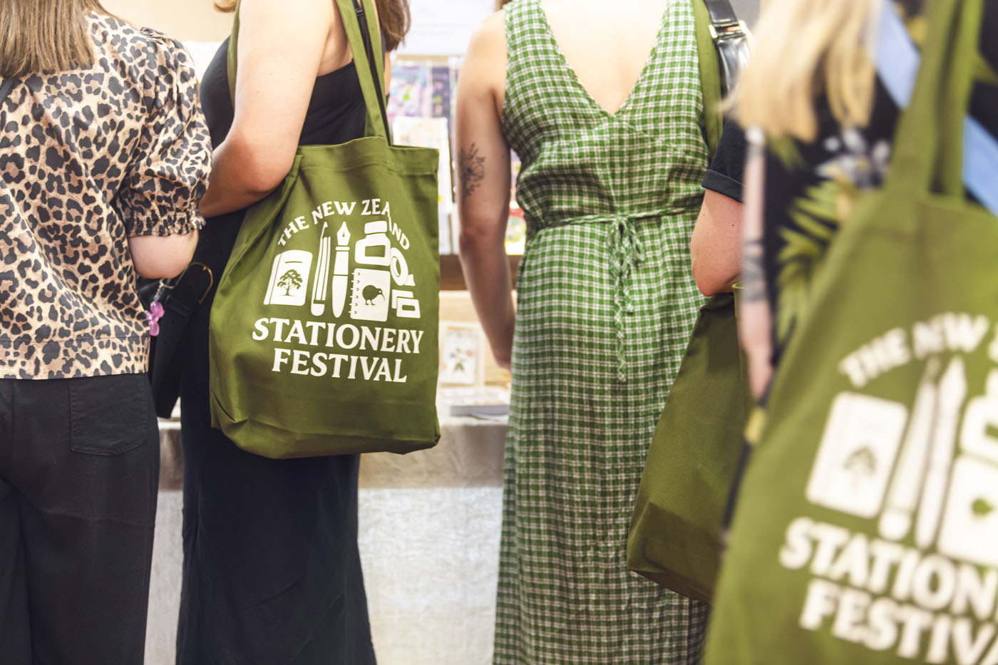 Ladies with special stationary festival tote bags over their shoulders