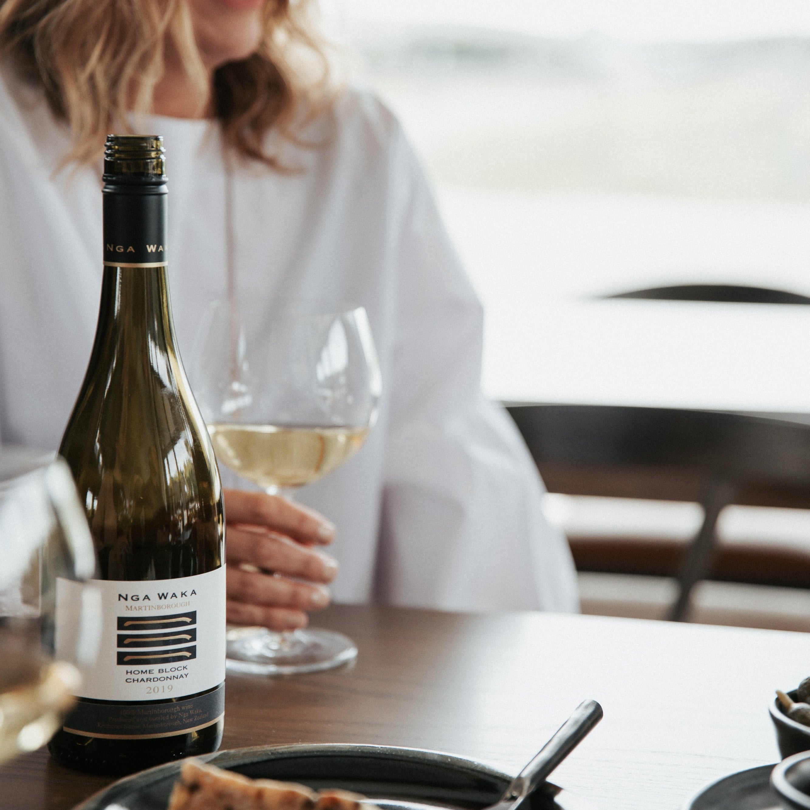 Lady drinking wine at table 