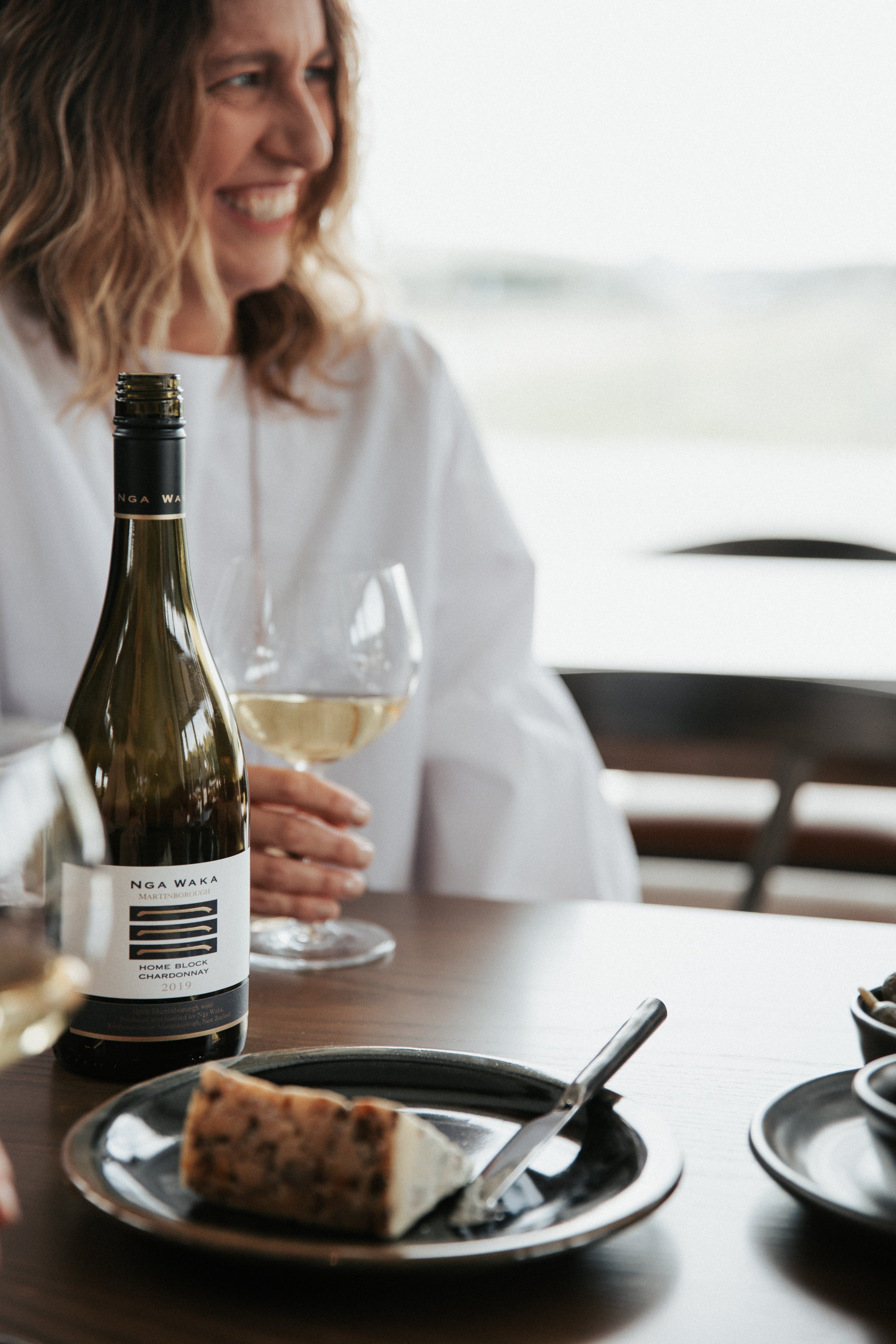 Lady drinking wine at table 