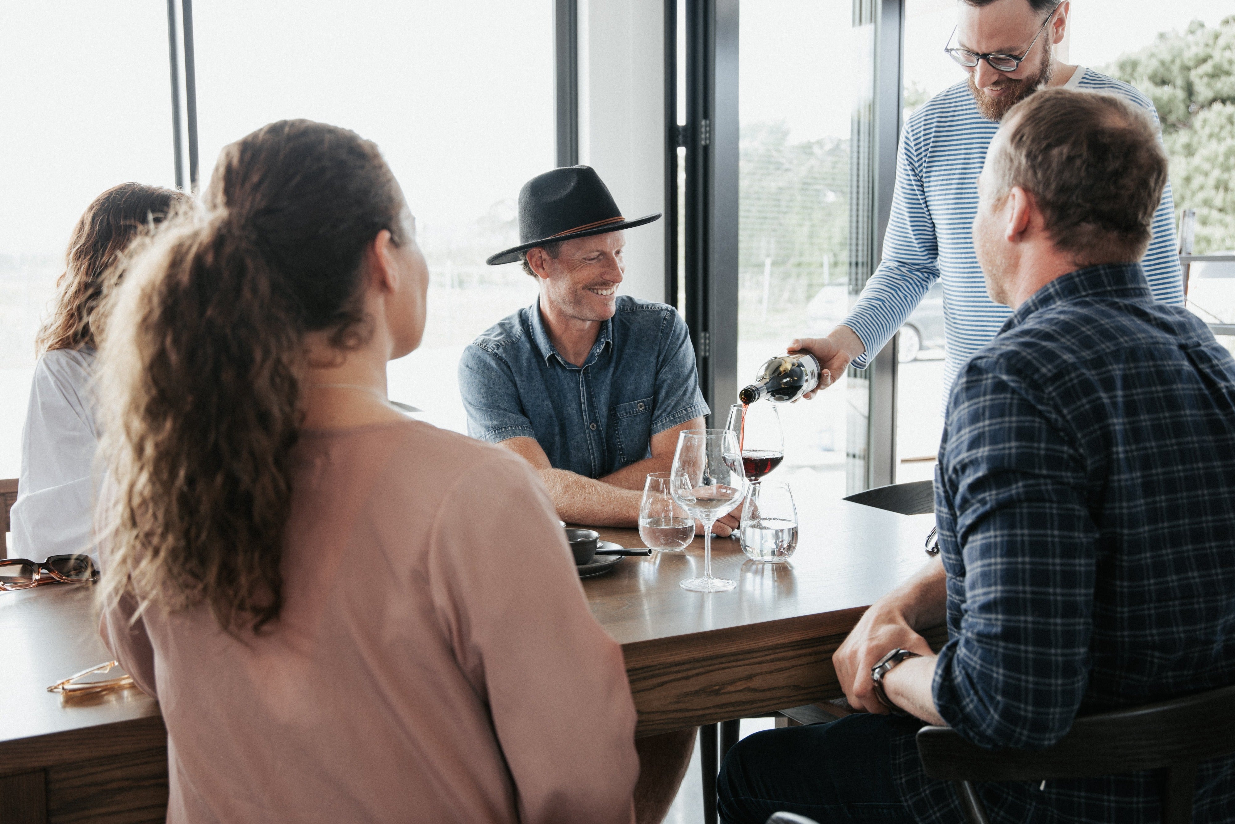 Man pouring wine at table 