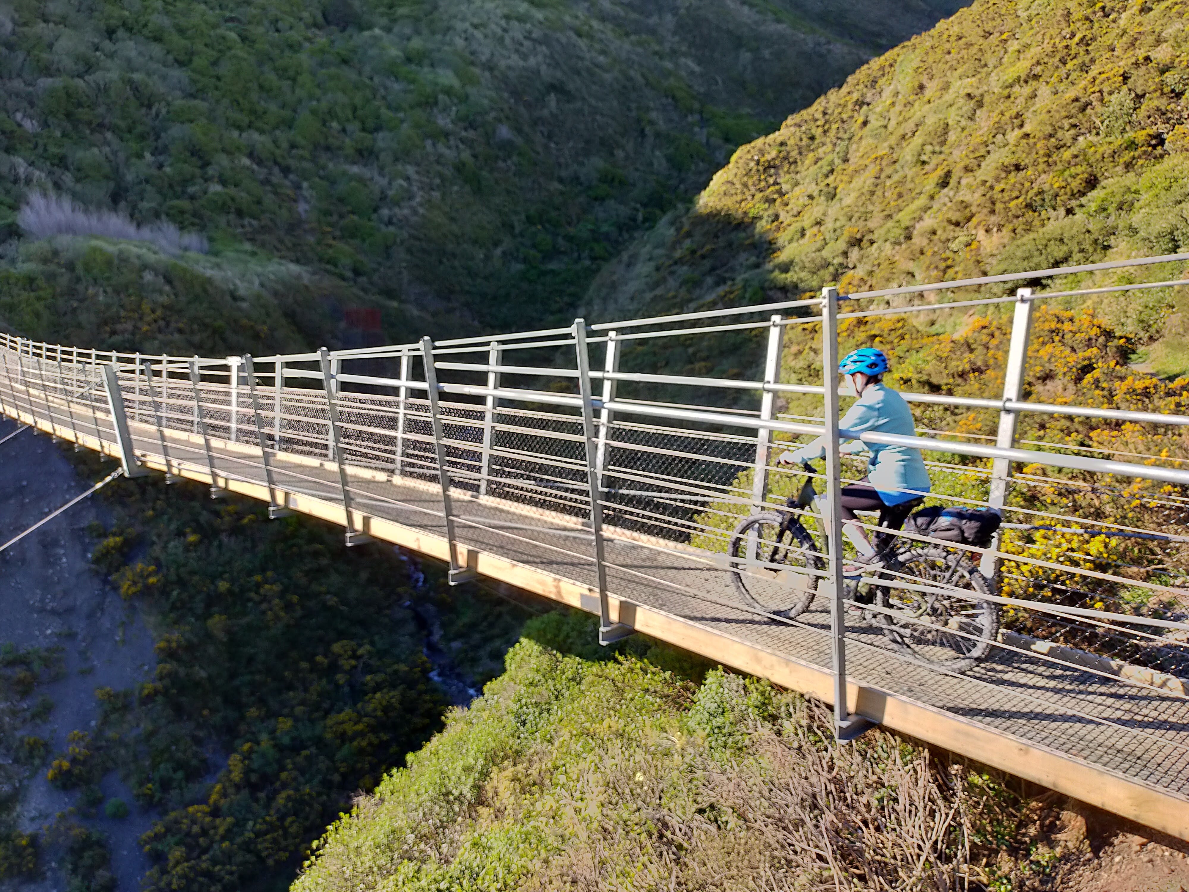 Rider crossing Siberia Gully Suspension Bridge.