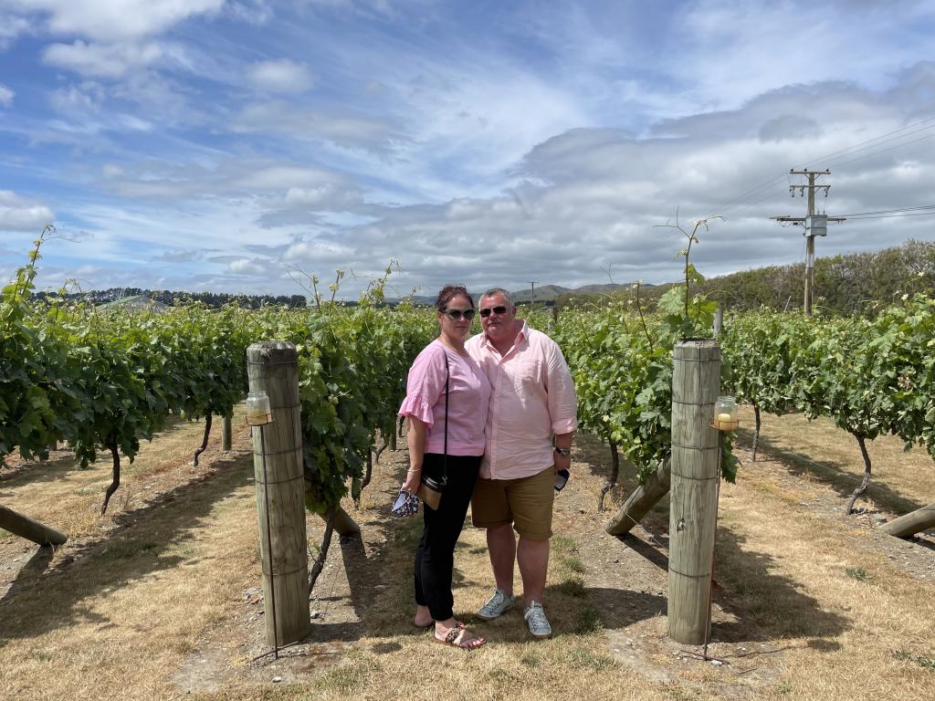 Guests enjoying a wander through the vines at Poppies Martinborough.