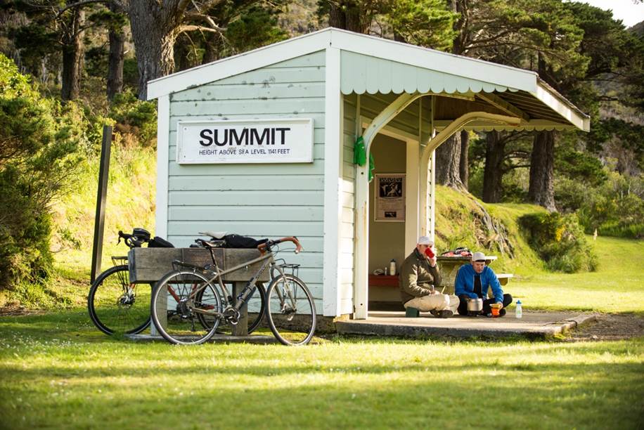 Cyclists picnicking at summit 