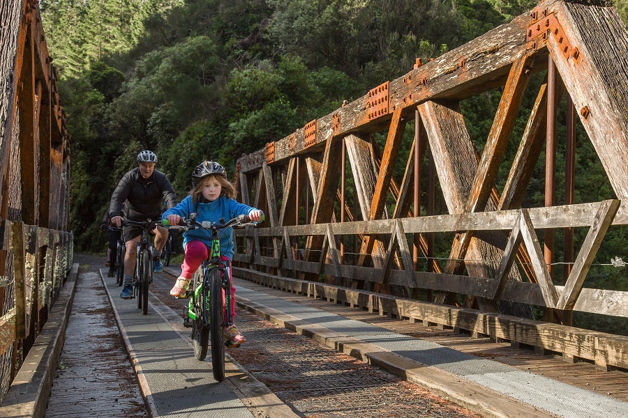 Family riding across bridge 