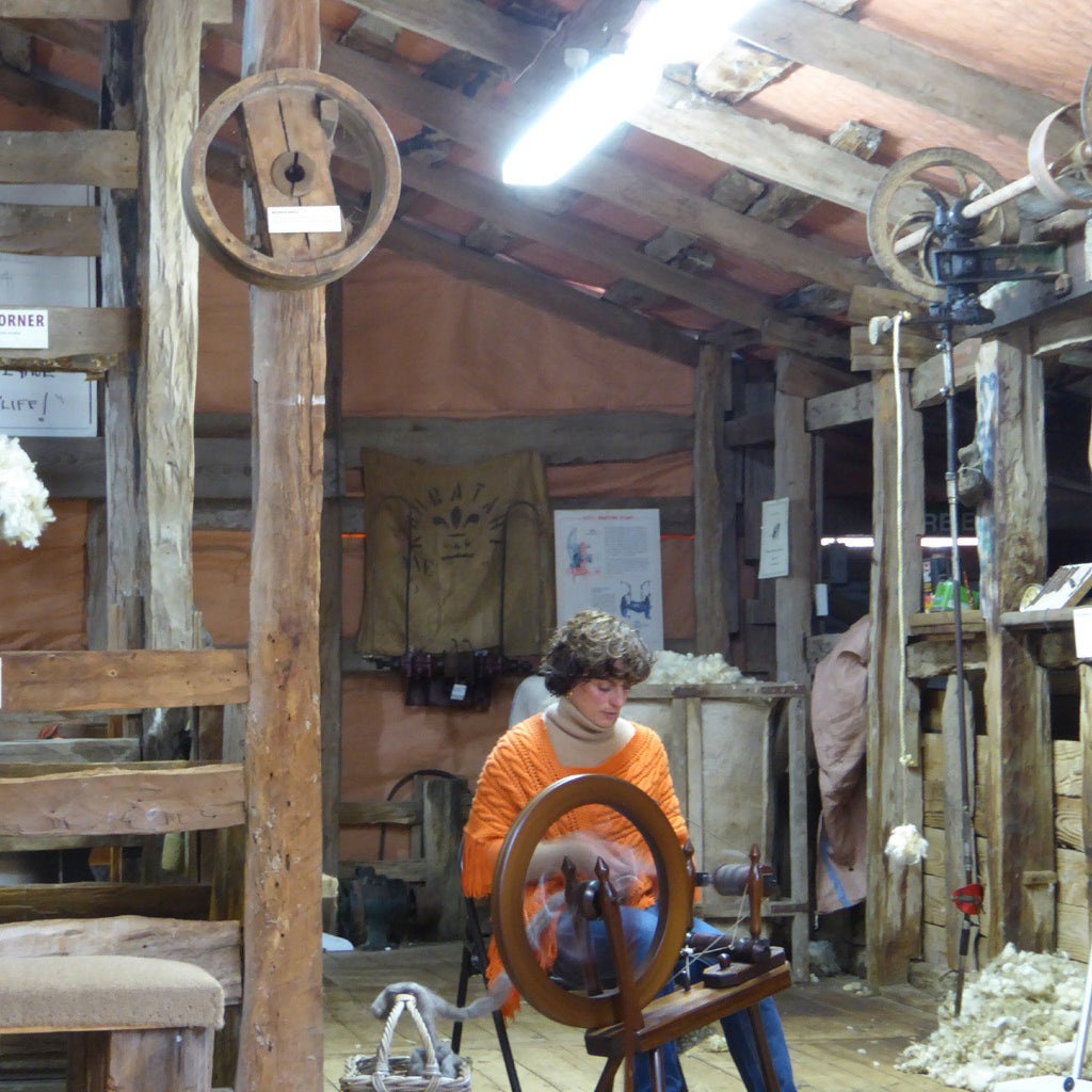 The owner spinning wool in a woolshed 