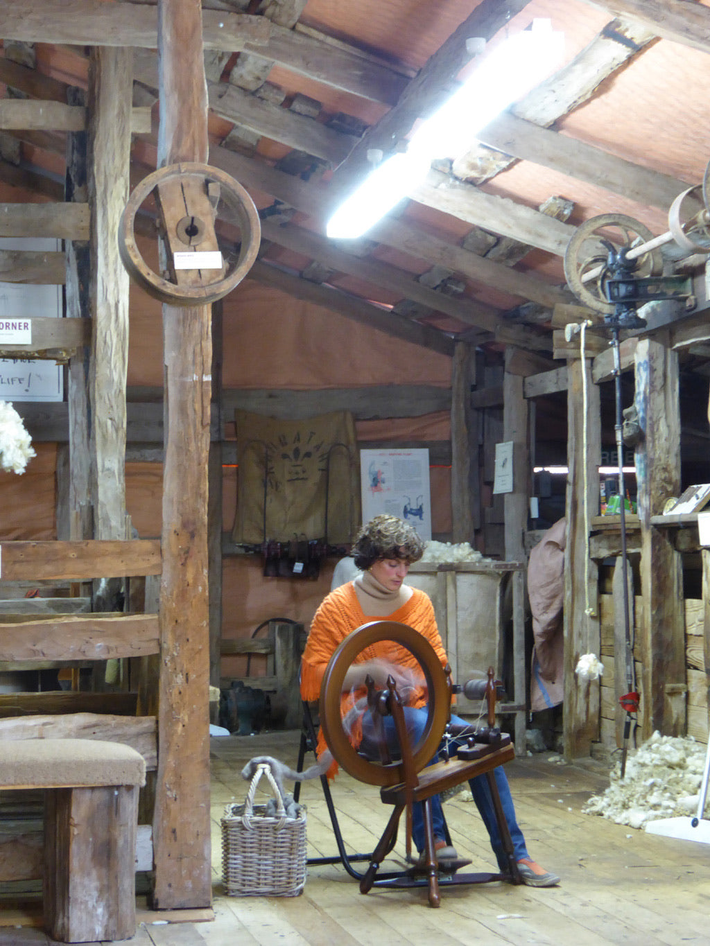 The owner spinning wool in a woolshed 