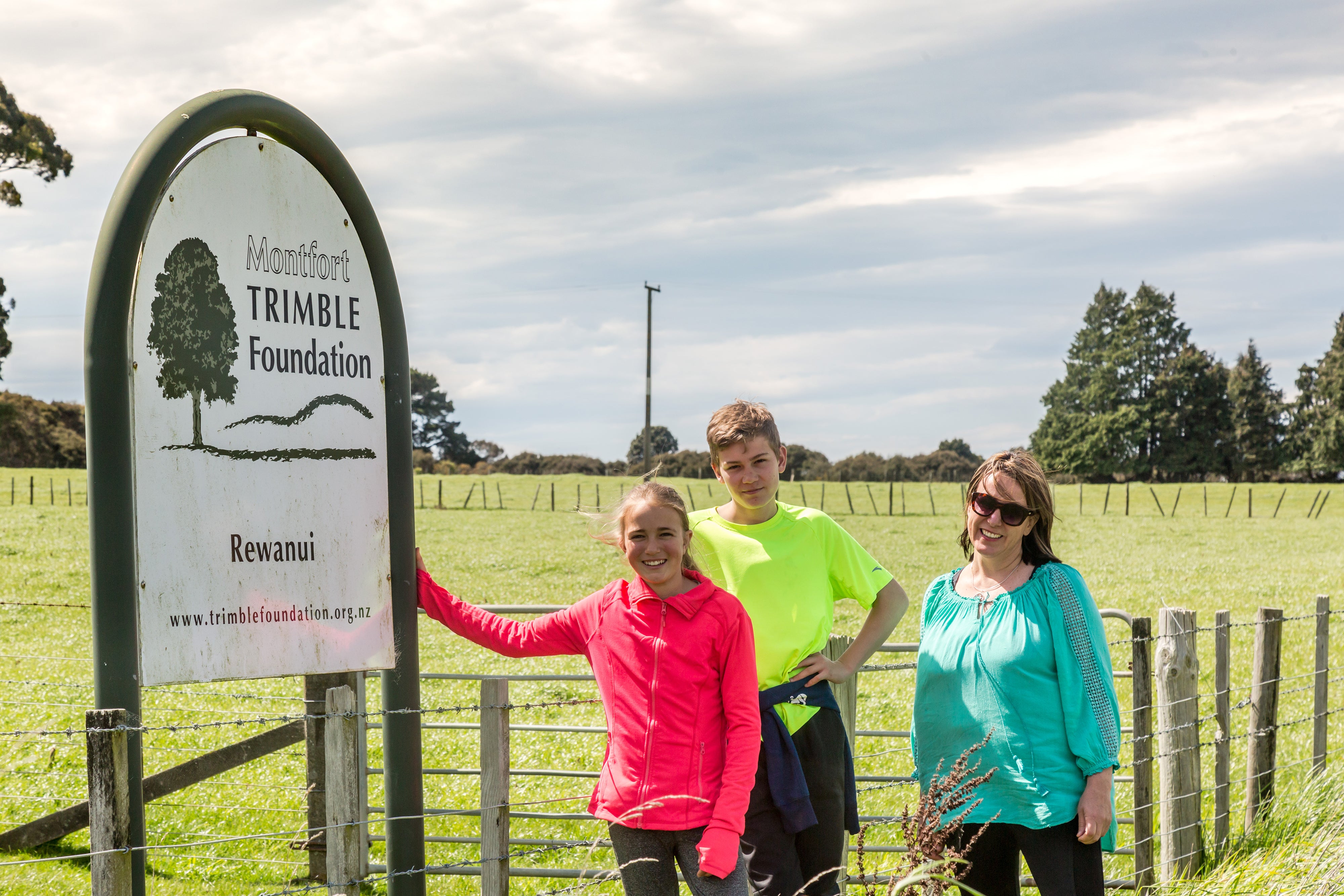 Family beside signpost 