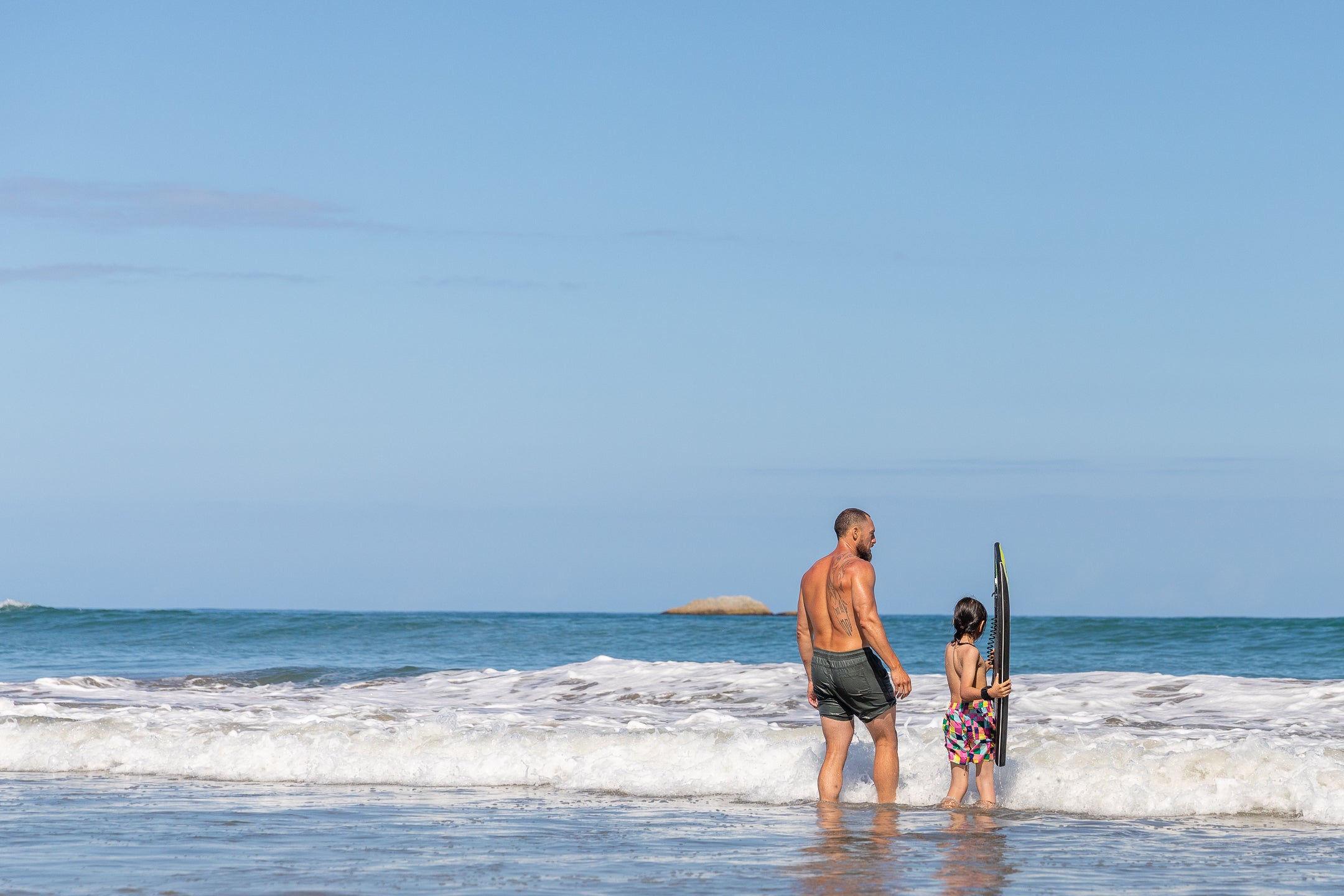 Father and son in the ocean at Riversdale Beach. 