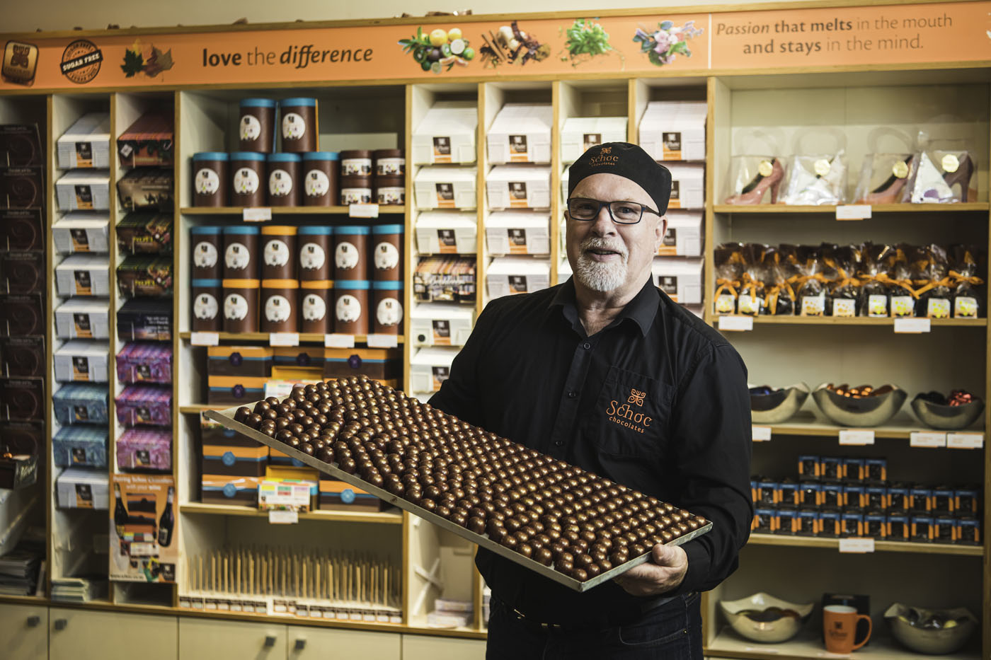 Owner holding tray of chocolates 