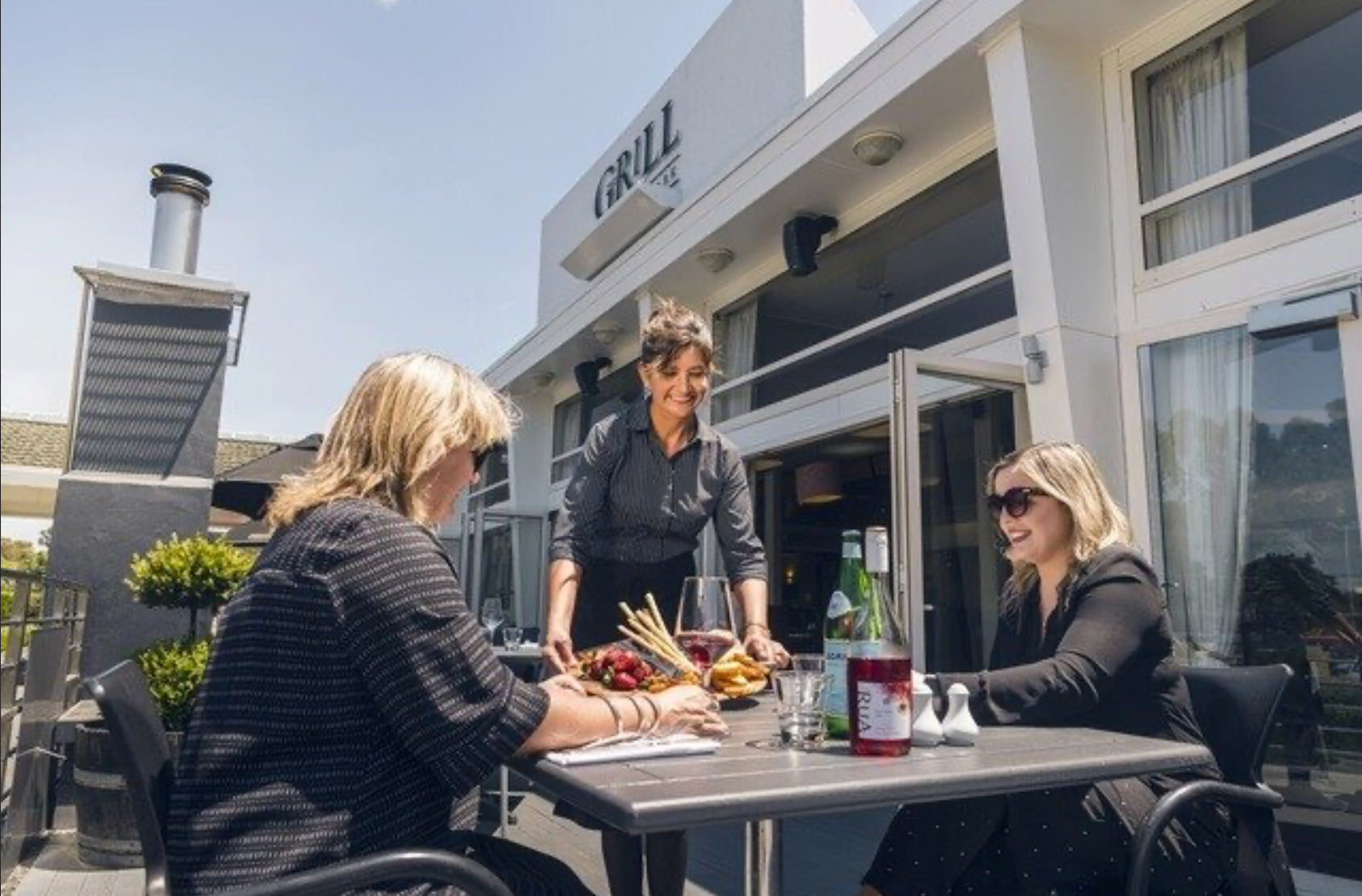 Two ladies being served a platter