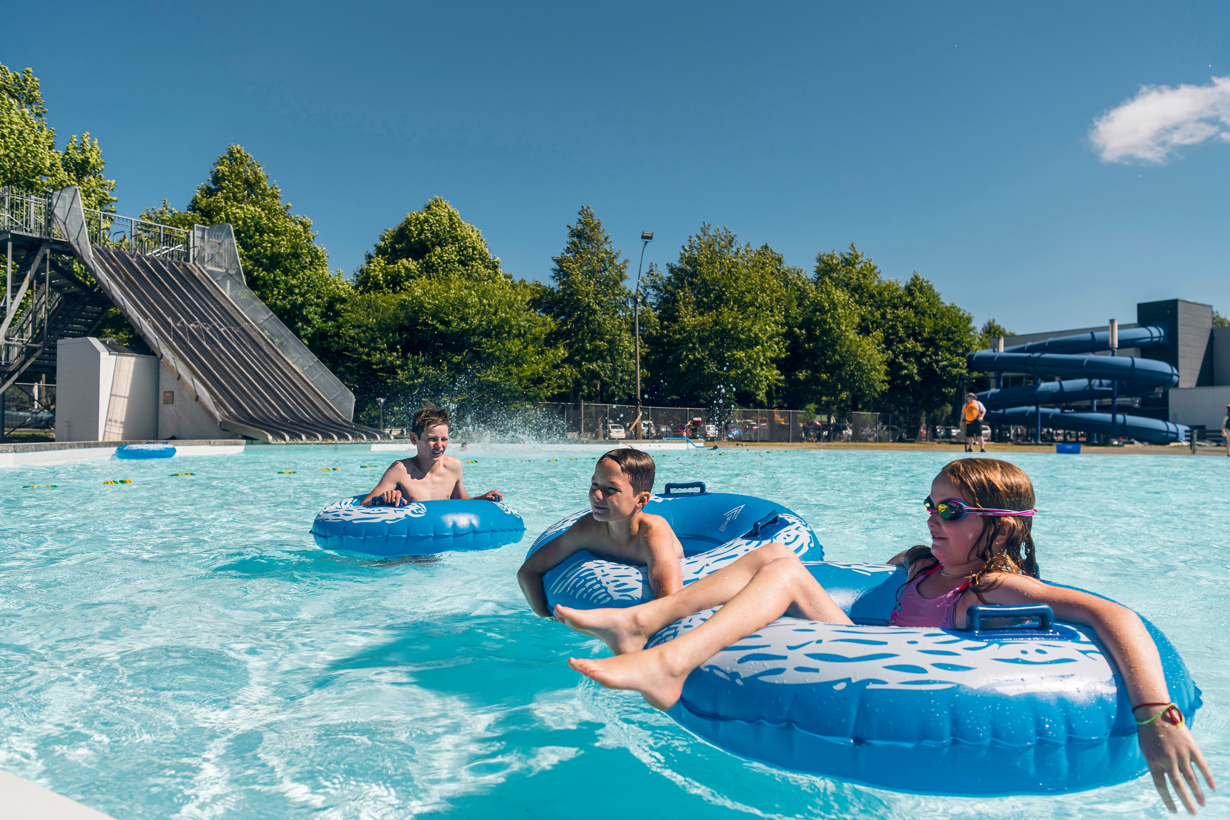 Kids on floaties in pool 