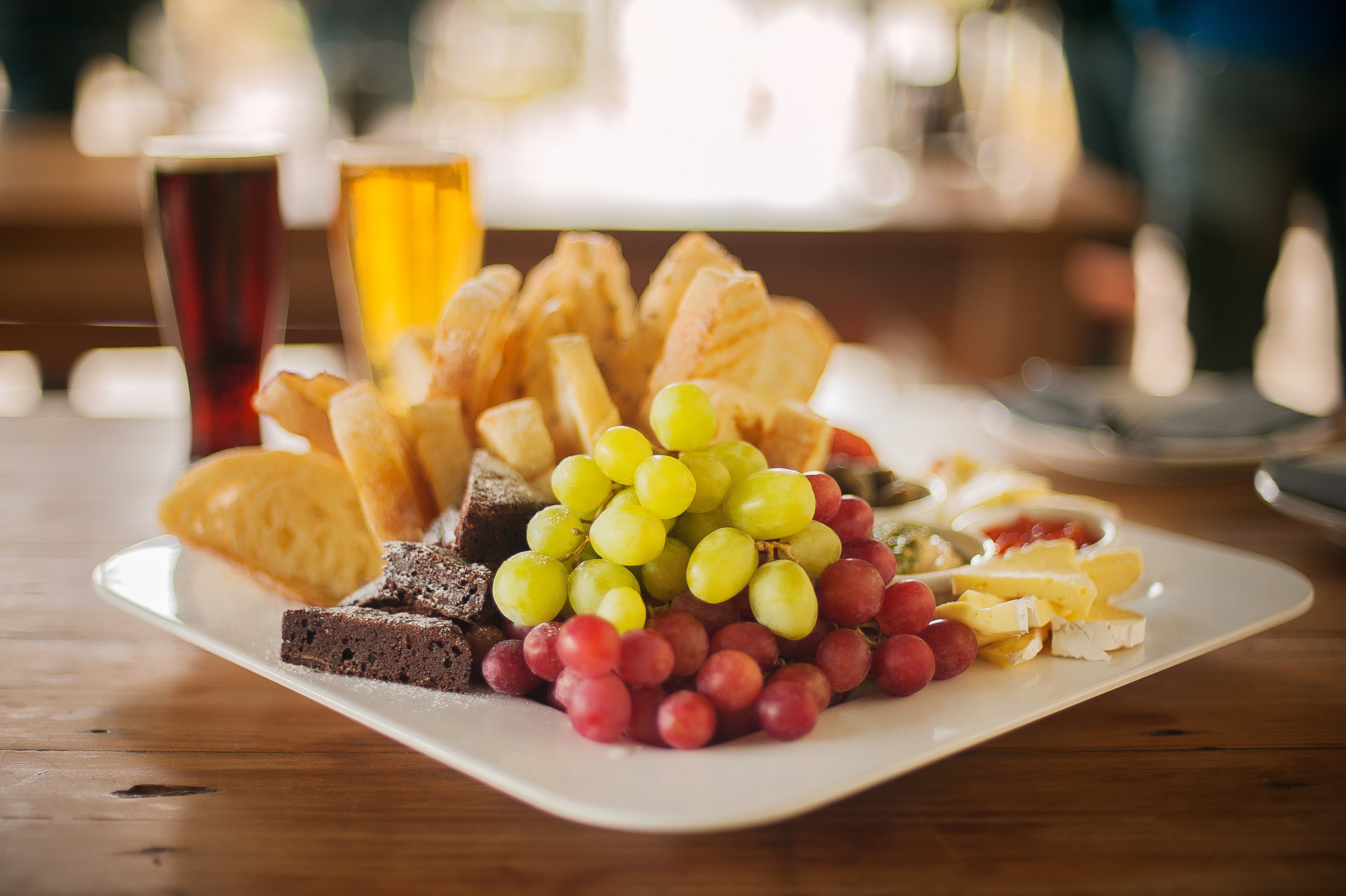 A platter of food with beer on the table 