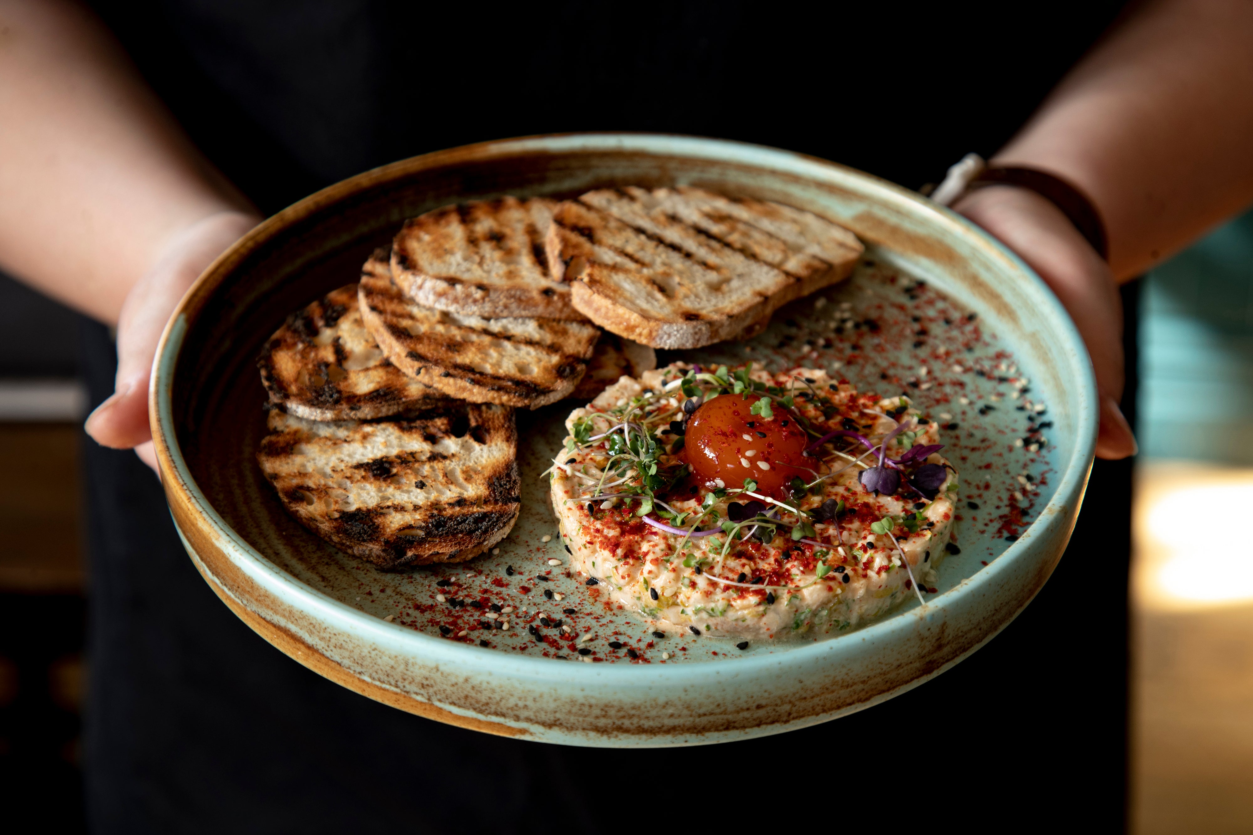 Waitress holding bowl of food 