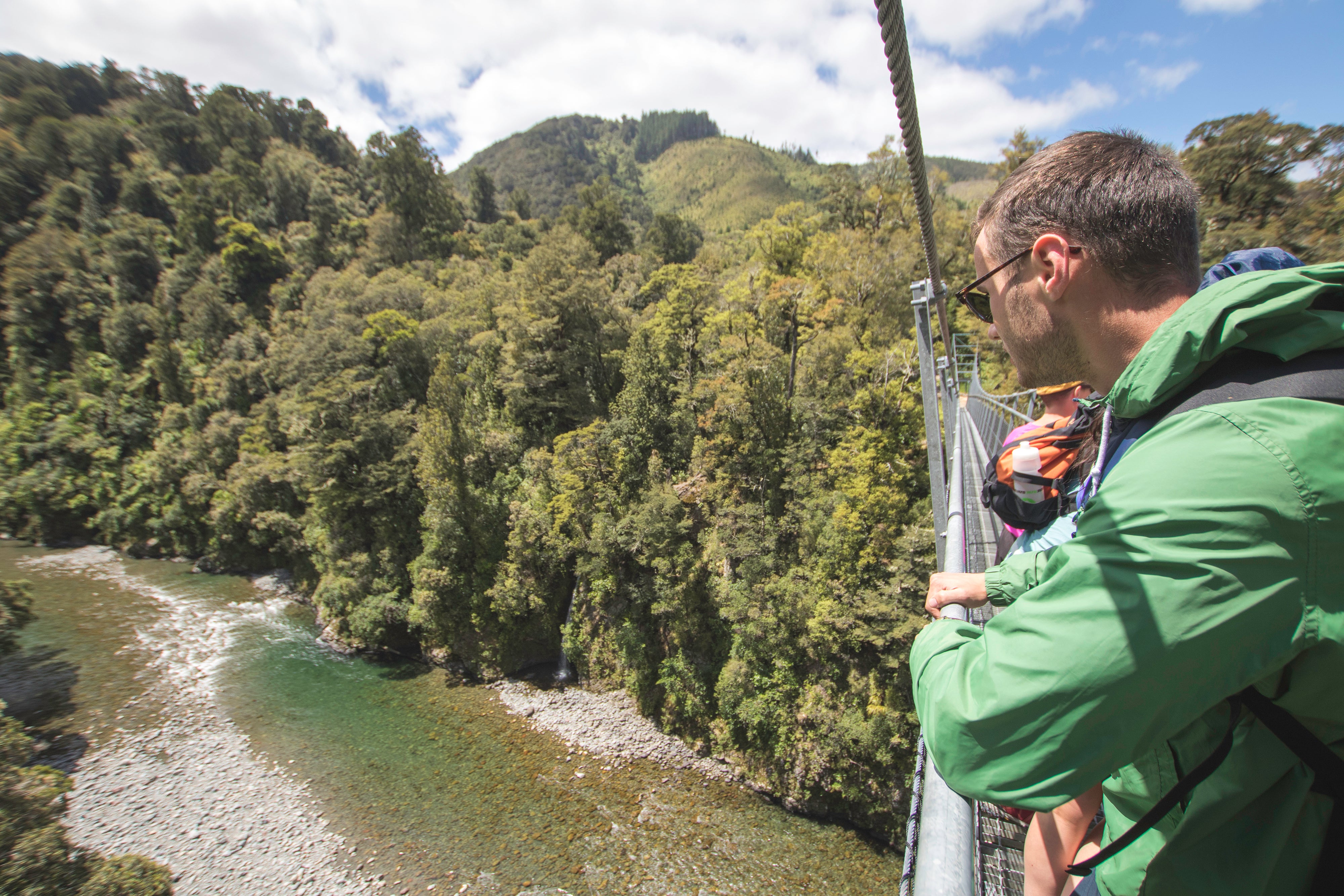 Man looking at view from bridge 