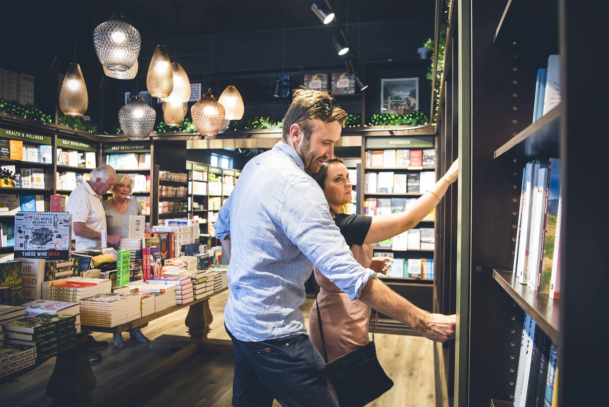 A couple browsing bookstore shelves