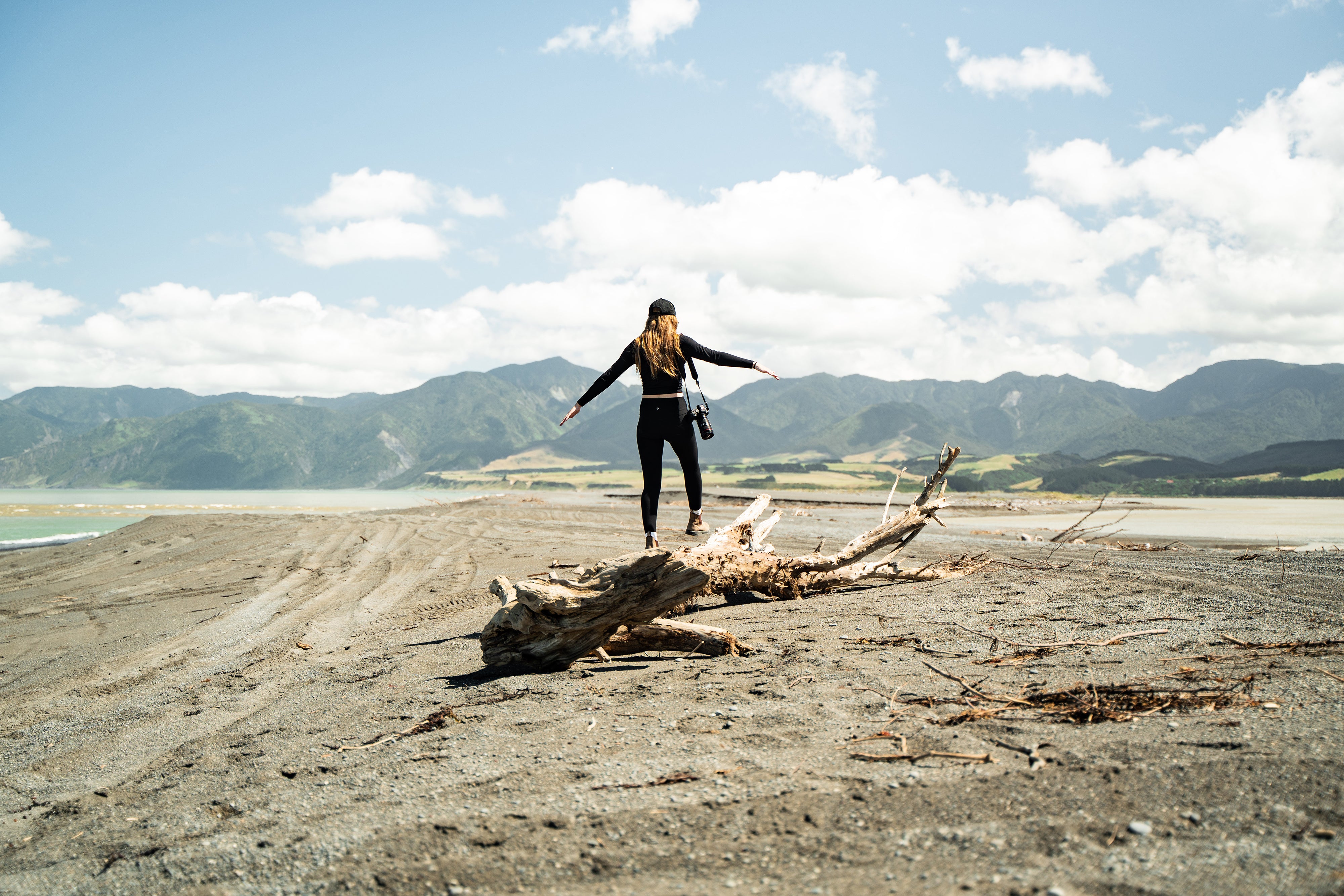 Girl walking along sand 