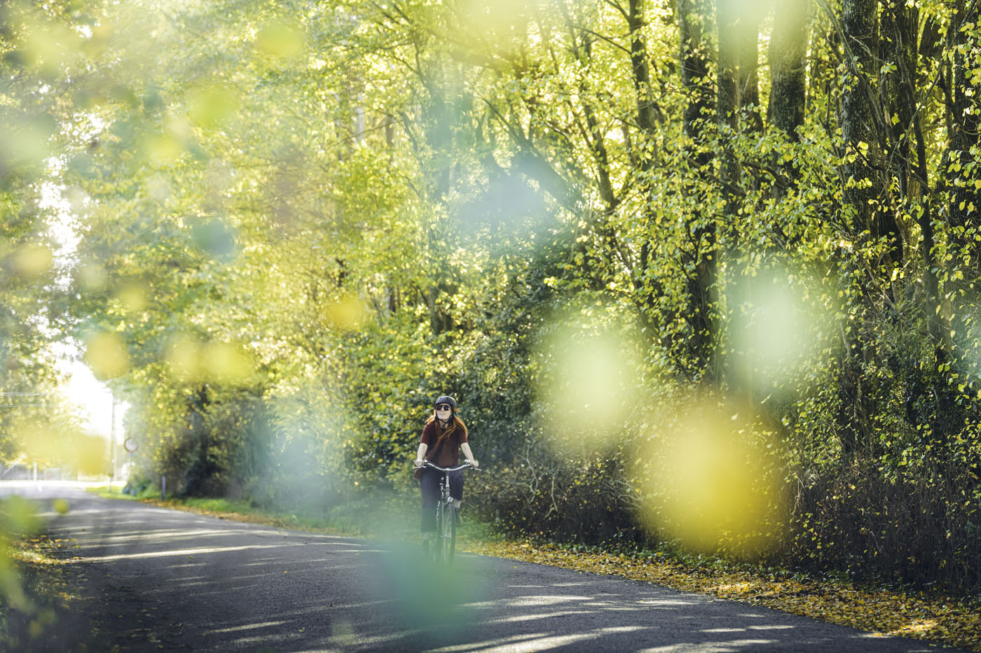 Lady riding through autumn trees 