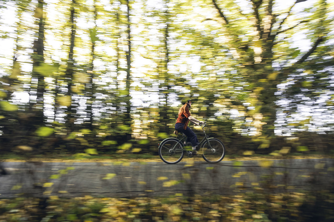 Lady riding through autumn trees 